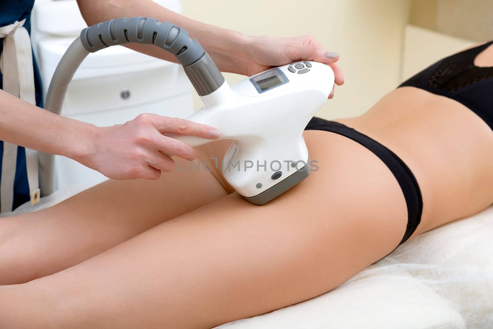 Masseur working with massage tool on a body of a client