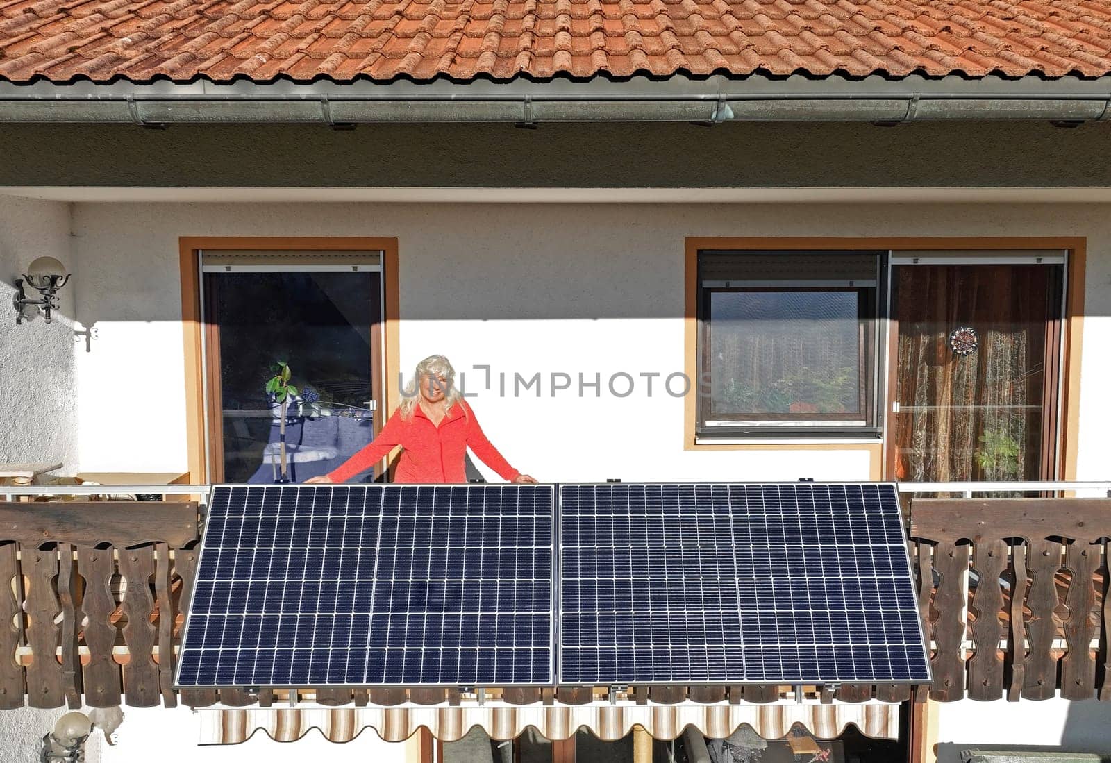A woman is happy about the new balcony power plant