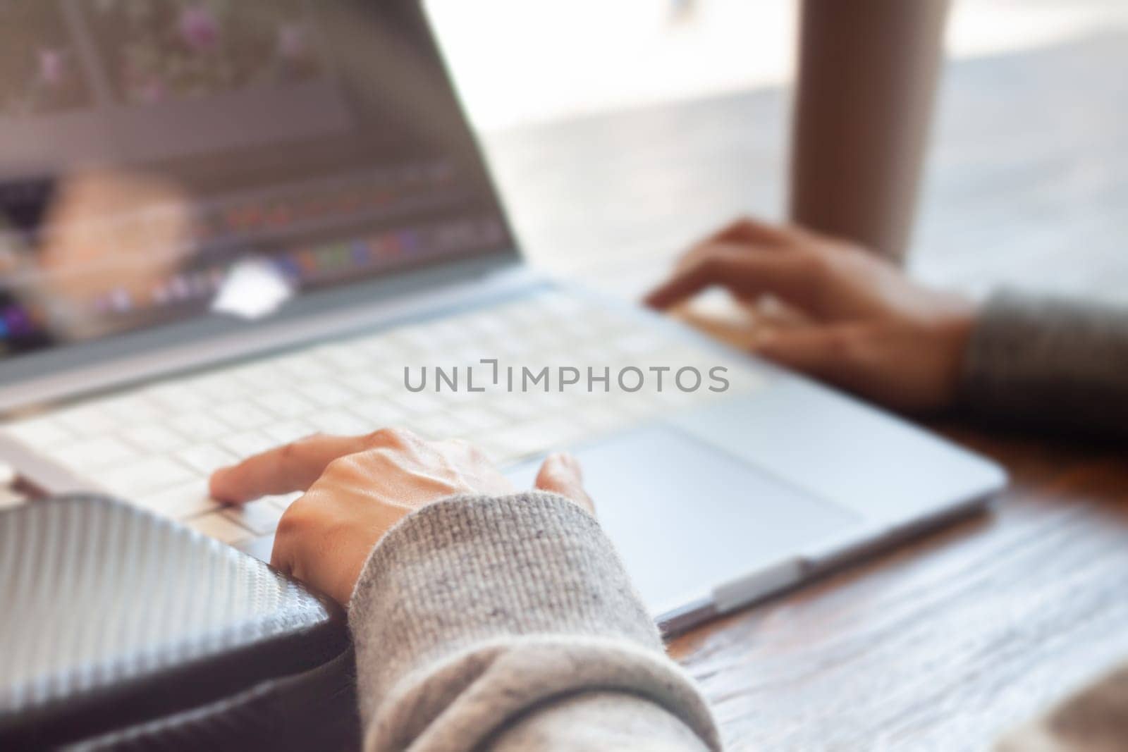 Woman working with a laptop, stock photo