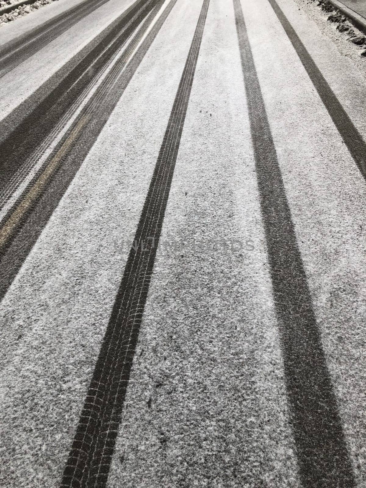white snowy road with car tracks