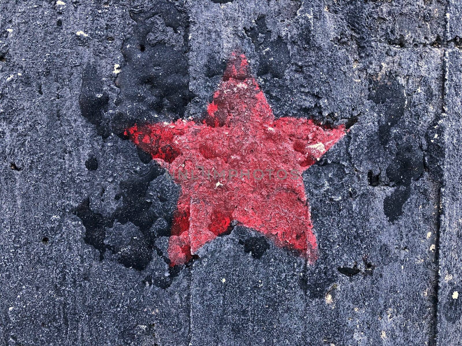 red five-pointed star on a black shabby background
