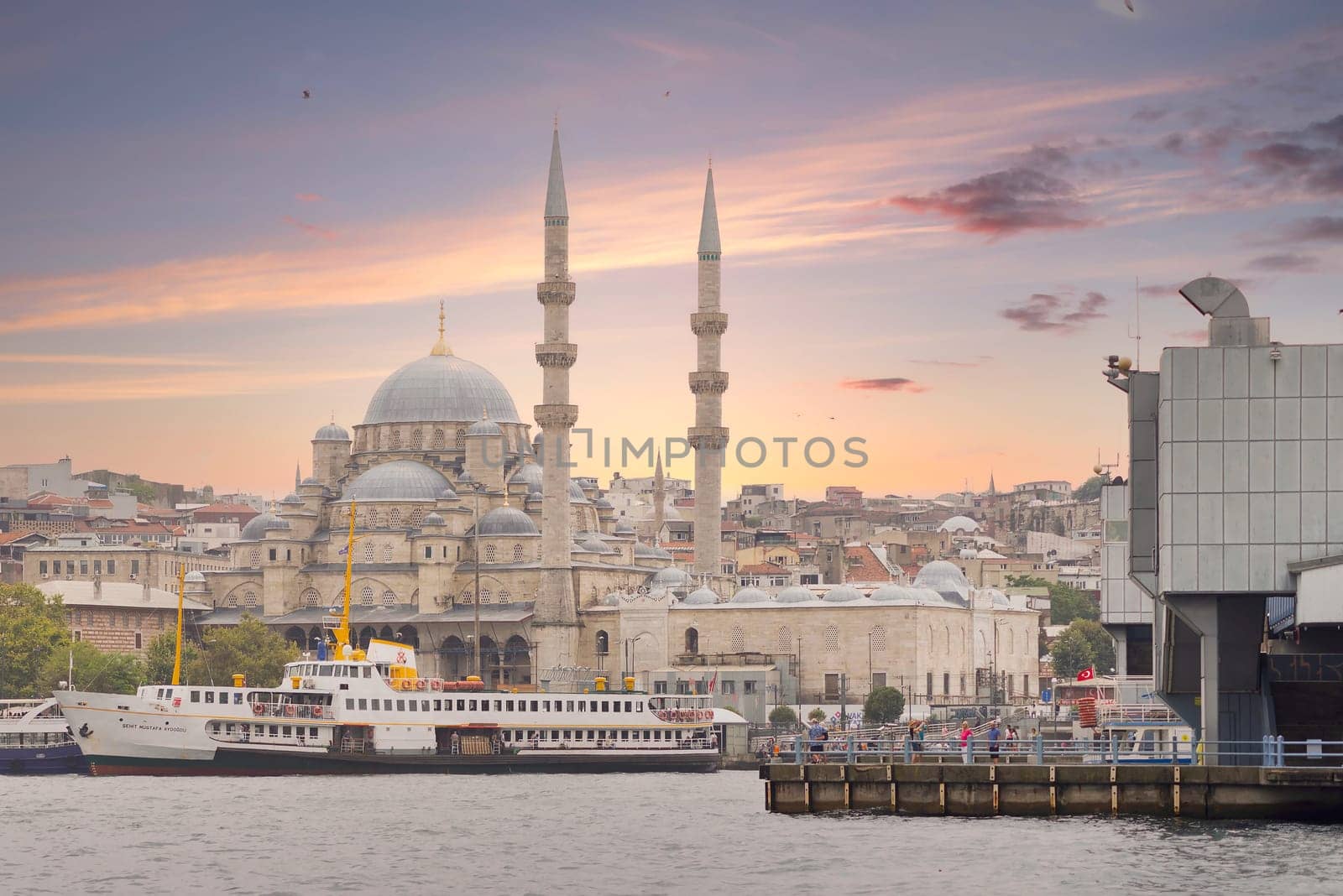 Istanbul, Turkey - August 25, 2022: Istanbul city view from Golden Horn overlooking Rustem Pasha Mosque, and part of Galata Bridge, before sunset