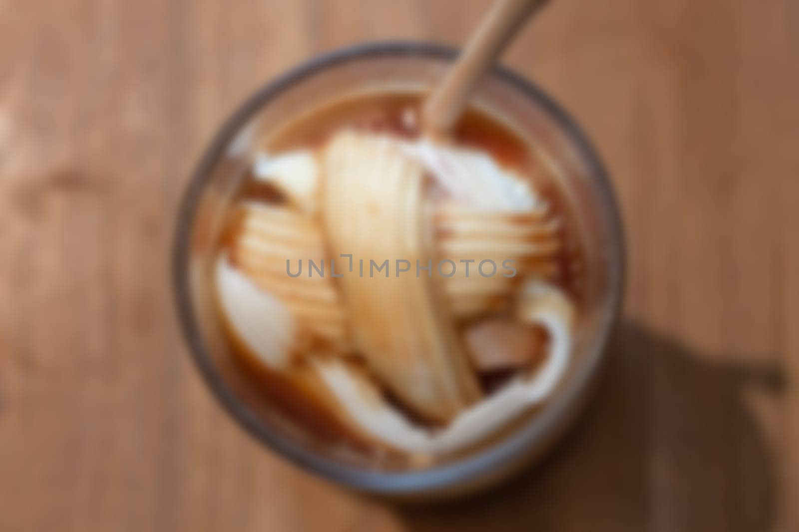 Glass of americano mixed with coconut blur background, stock photo