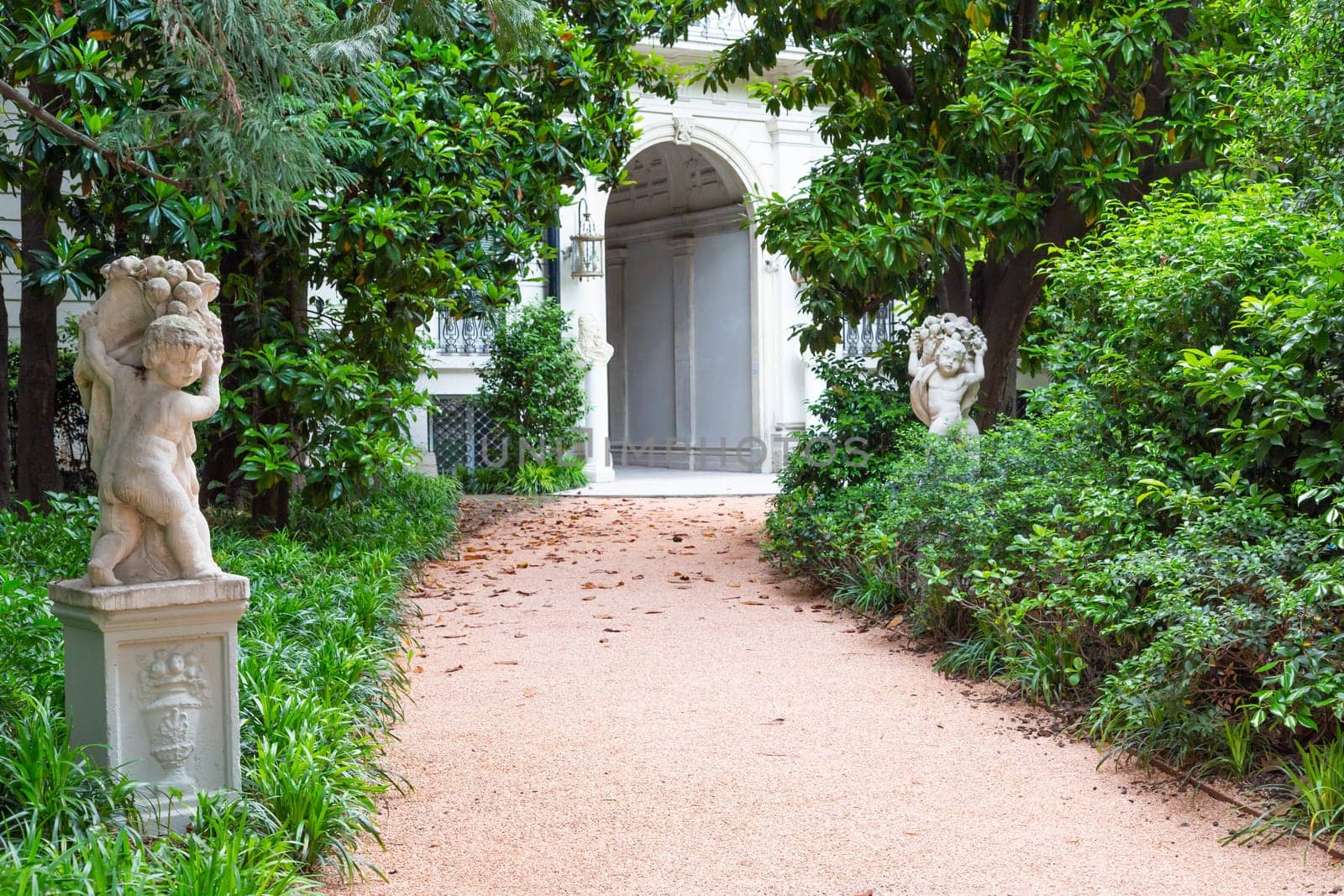 Milan, Italy - Circa June 2021: Italian Villa entrance with garden. Luxurious green exterior
