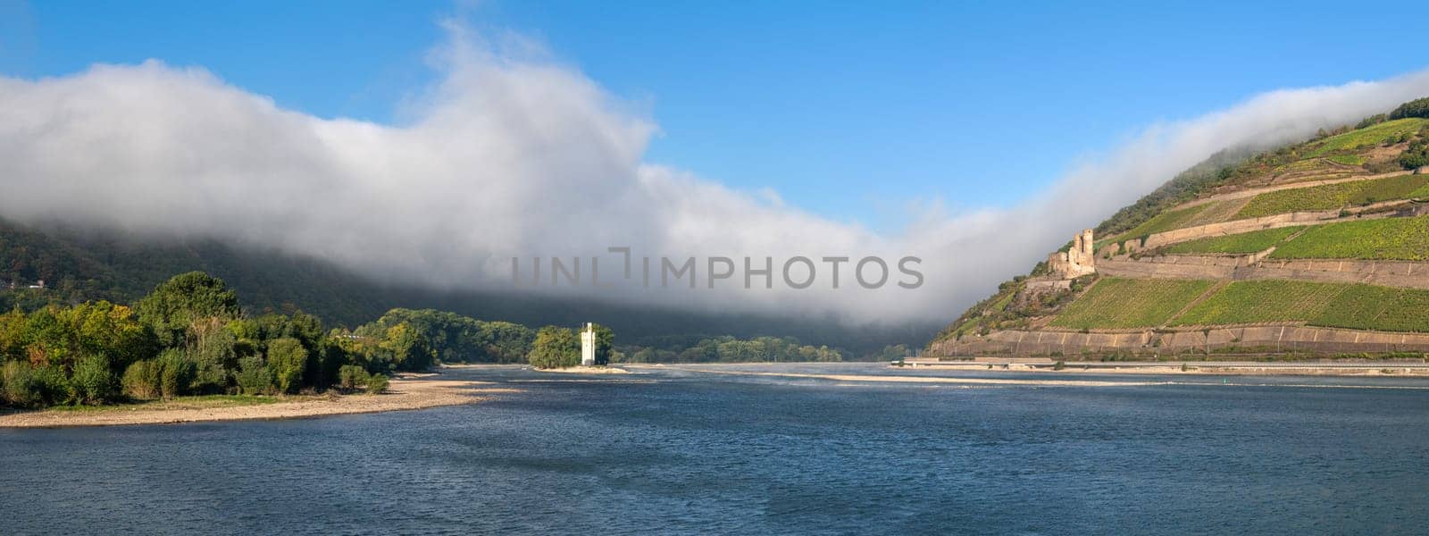 BINGEN, GERMANY - OCTOBER 8, 2021: Mouse tower within the Rhine river against dramatic clouds on October 8, 2021 in Bingen, Rhine valley, Germany