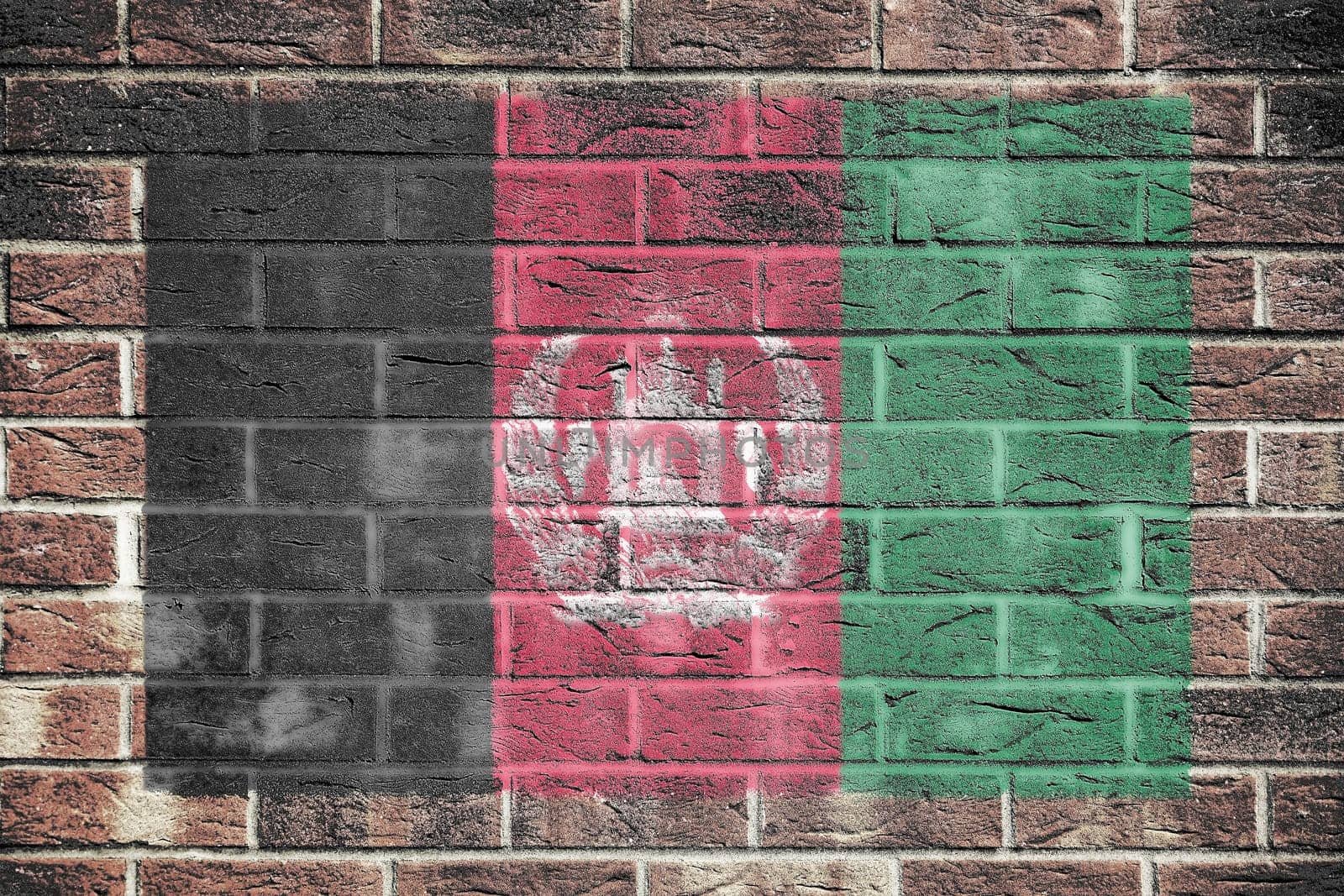 An Afghanistan flag on a brick wall background