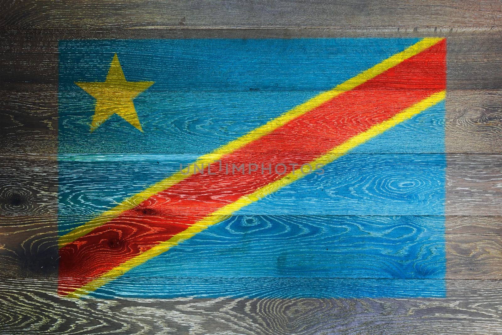 A Democratic Republic of Congo flag on rustic old wood surface background
