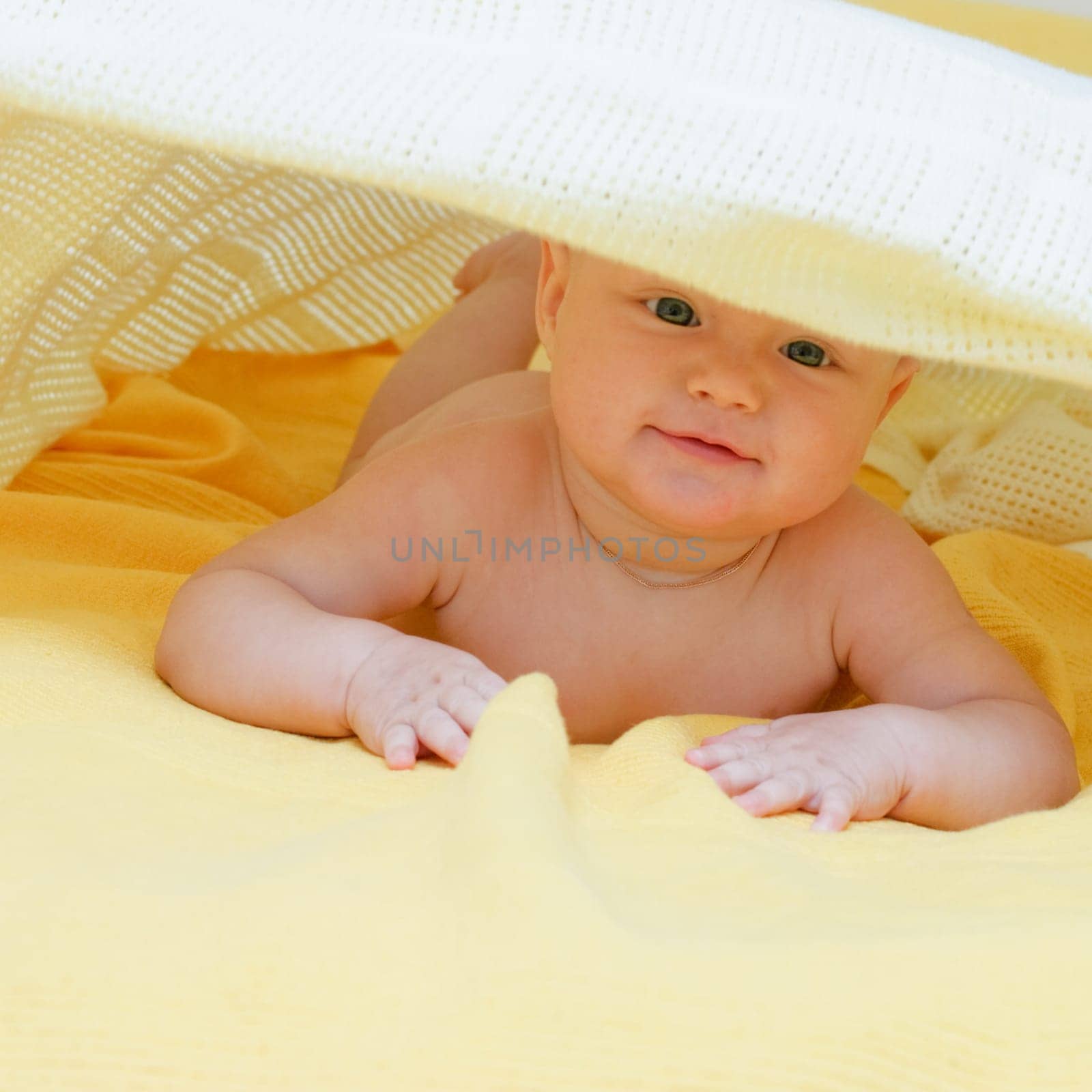 Seven month baby girl playing with blanket