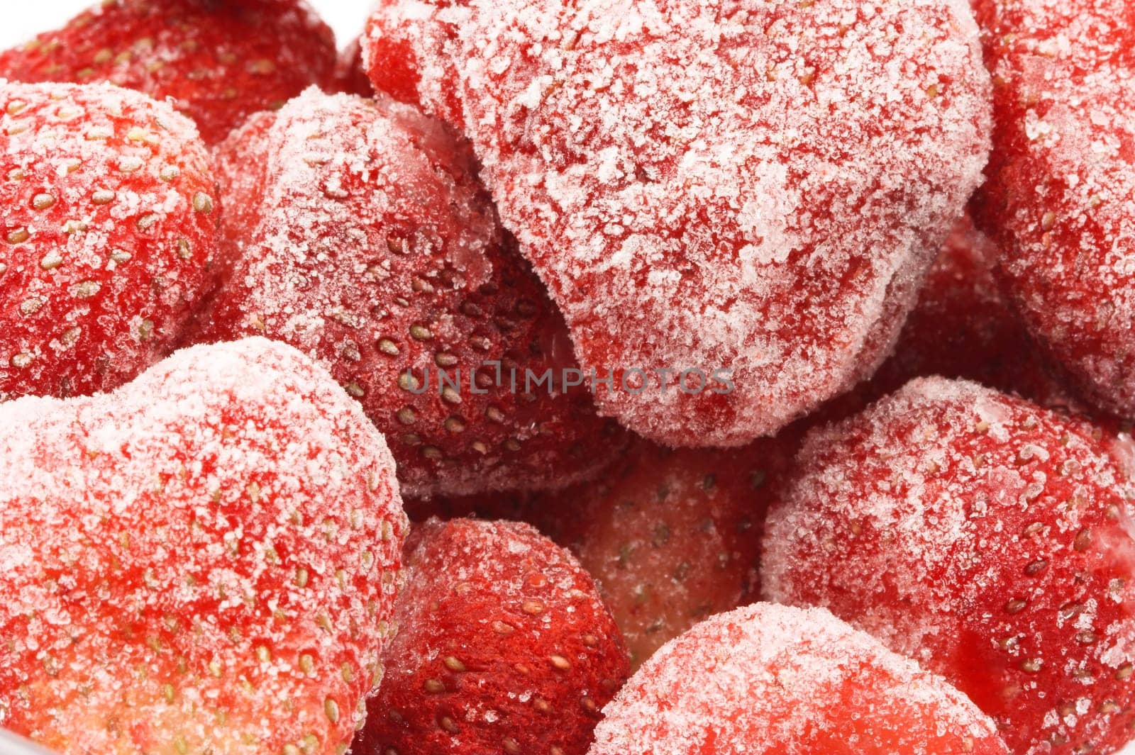 Heap of frozen strawberries closeup.