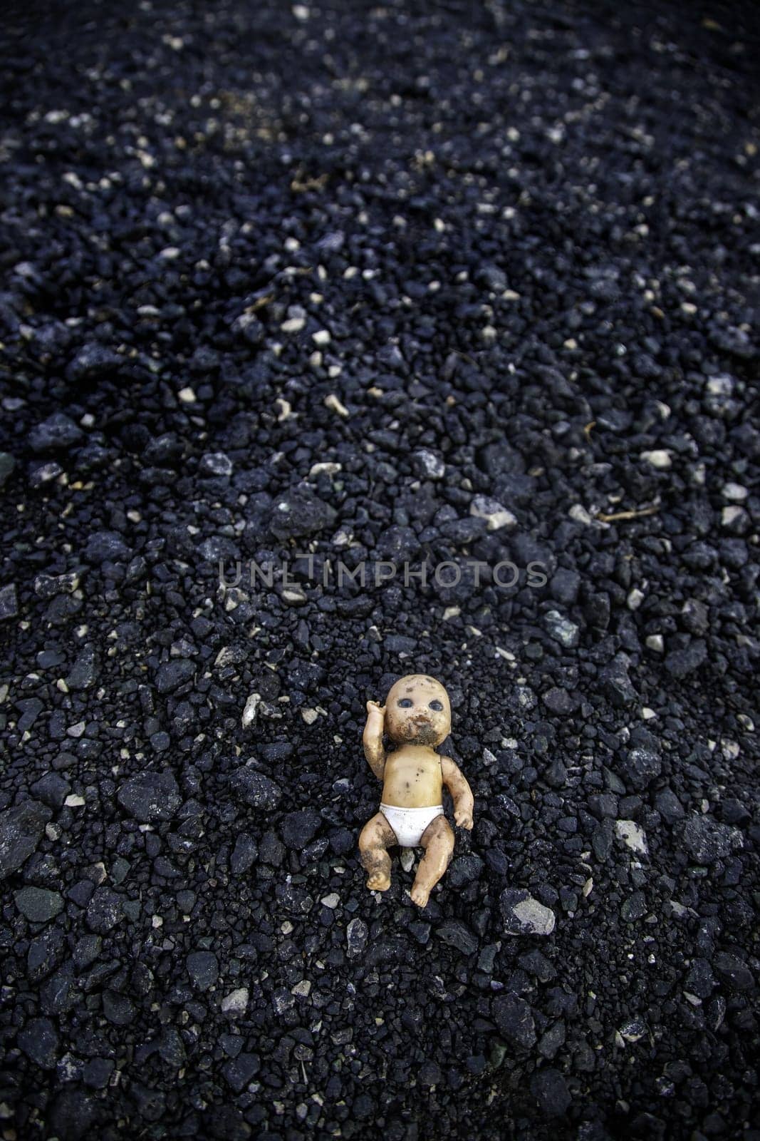Detail of old and dirty toy in the trash