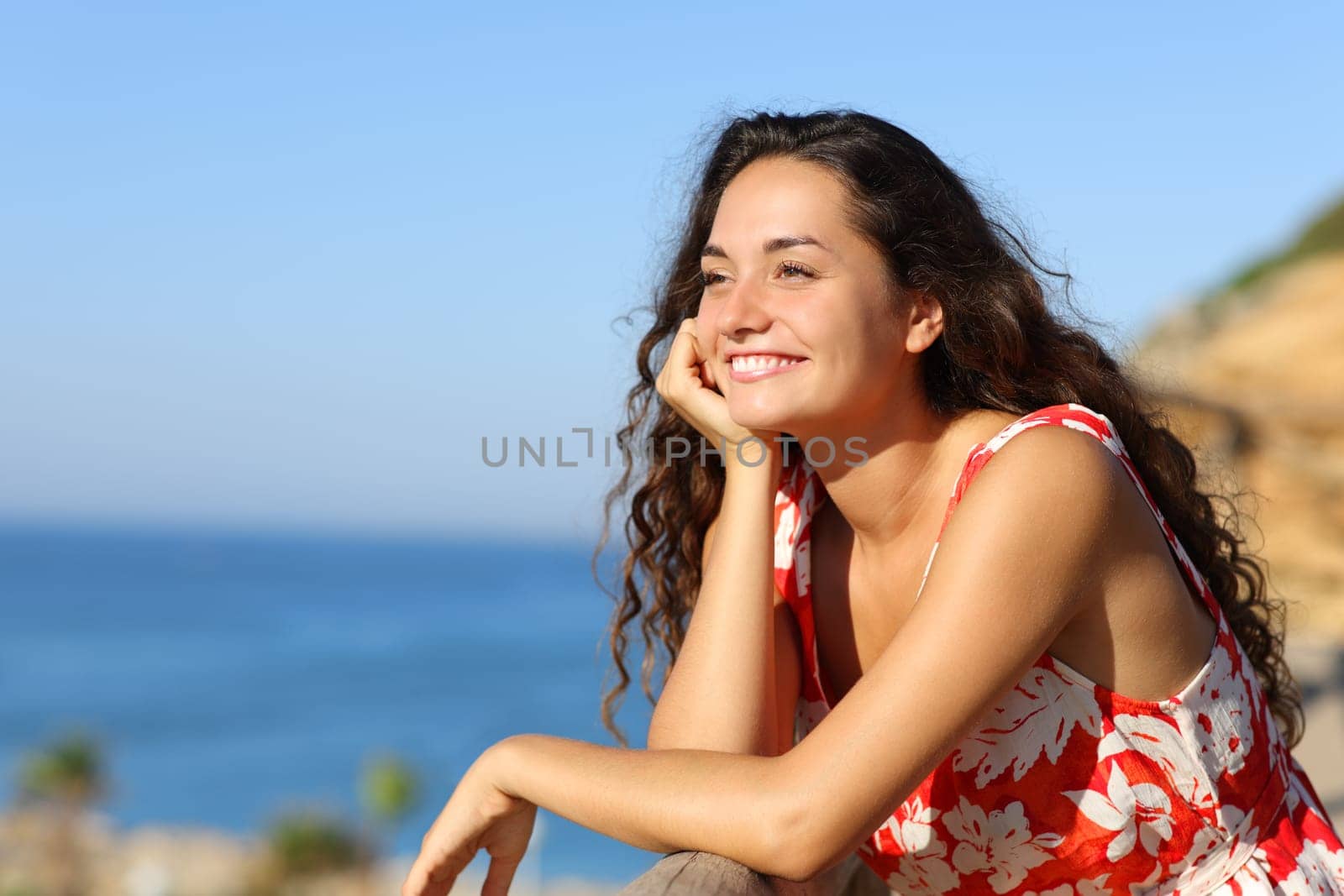 Happy tourist contemplating beach views on summer vacation