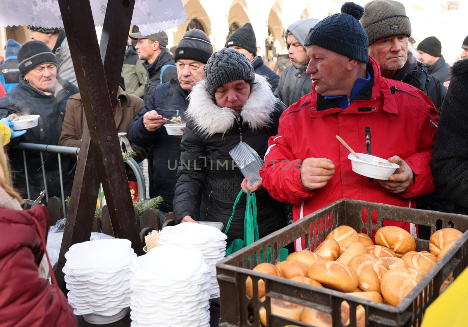 Krakow, Poland - Dec 18, 2022: Christmas Eve for poor and homeless on the Main Square in Cracow. The group Kosciuszko prepares the greatest eve in the open air in Krakow