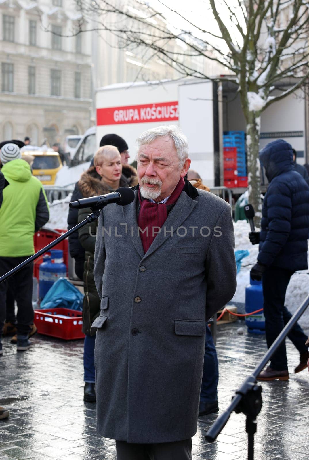Cracow, Poland - Dec 18, 2022: President of Krakow Jacek Majchrowski participates in the Christmas Eve for the poor and homeless on the Main Square in Cracow.