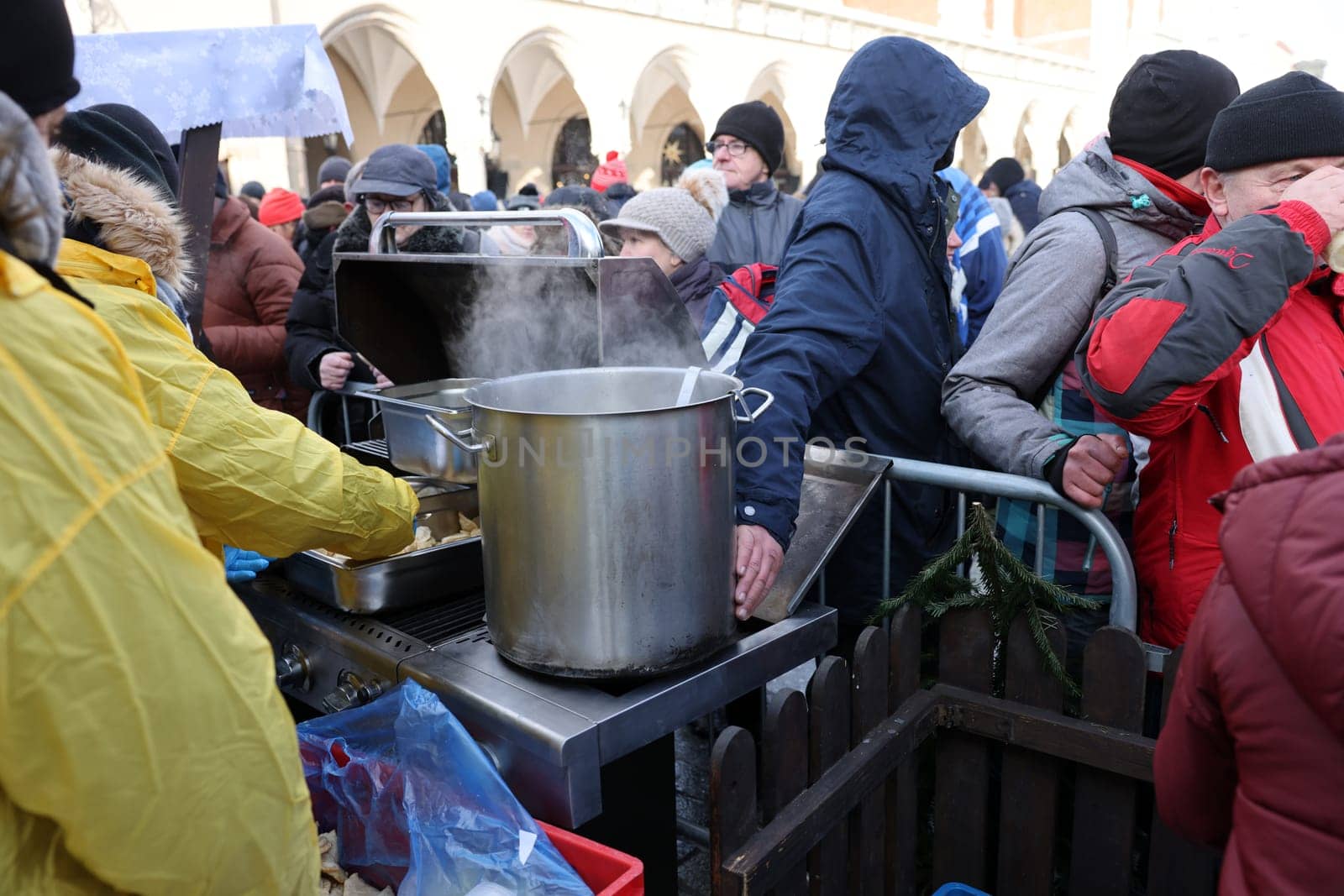 Krakow, Poland - Dec 18, 2022: Christmas Eve for poor and homeless on the Main Square in Cracow. The group Kosciuszko prepares the greatest eve in the open air in Krakow