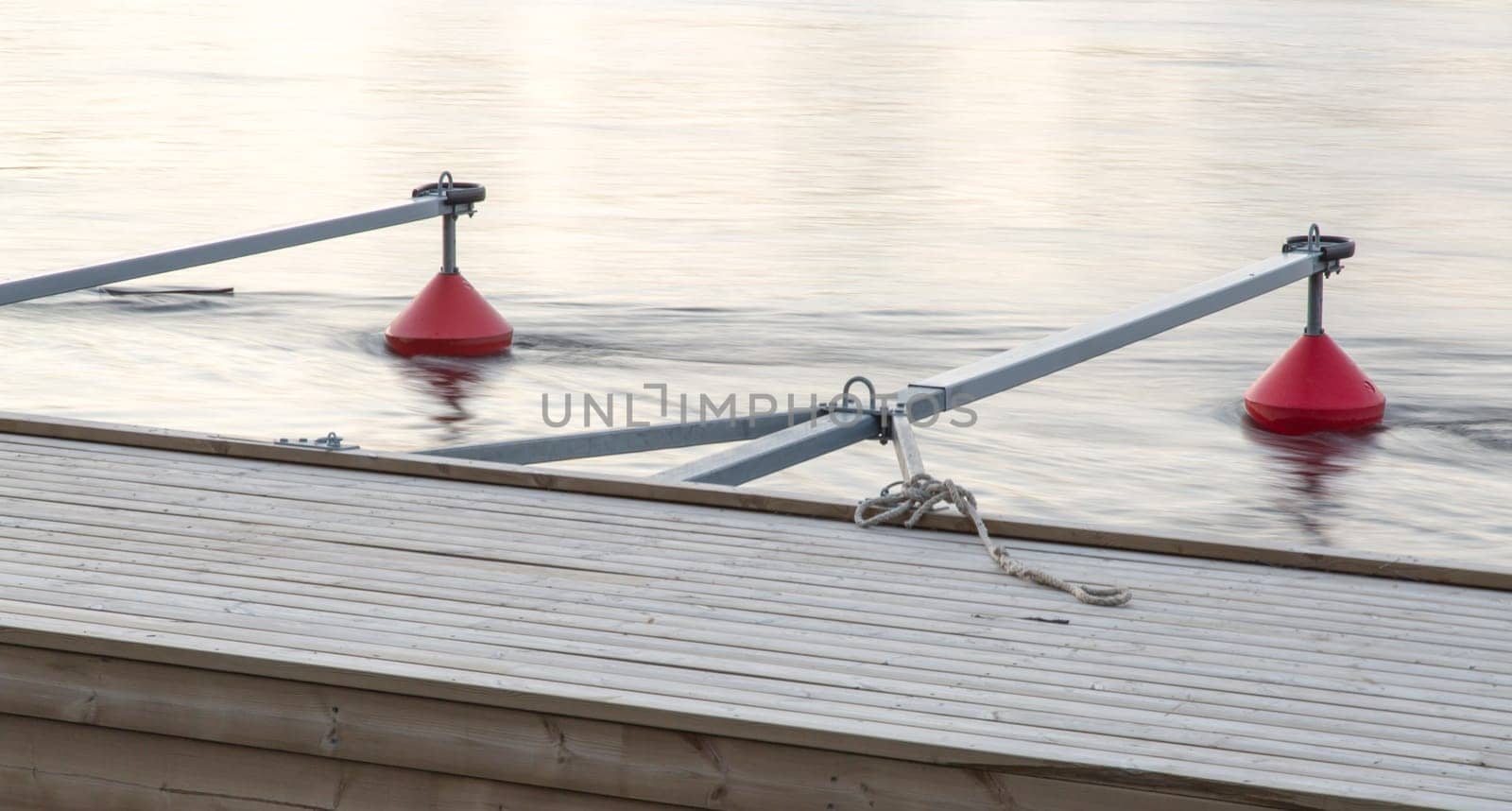 Small Boat Marina in River with orange buoys.