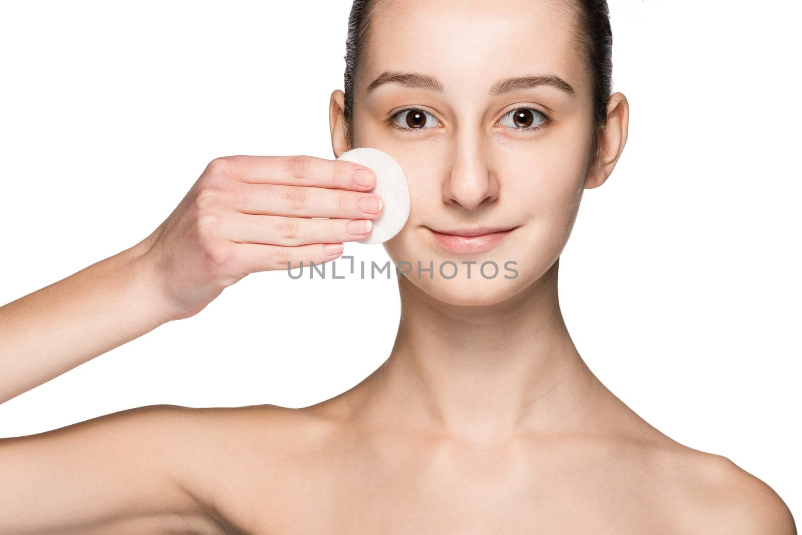skin care woman removing face with cotton swab pad - skin care concept. Facial closeup of beautiful Caucasian model with perfect skin. Girl isolated on white background