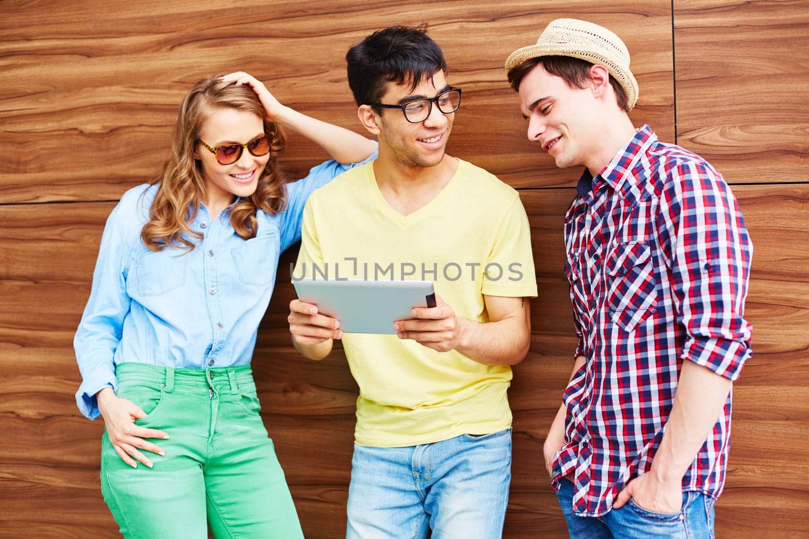 Modern teenagers with touchpad spending leisure outdoors