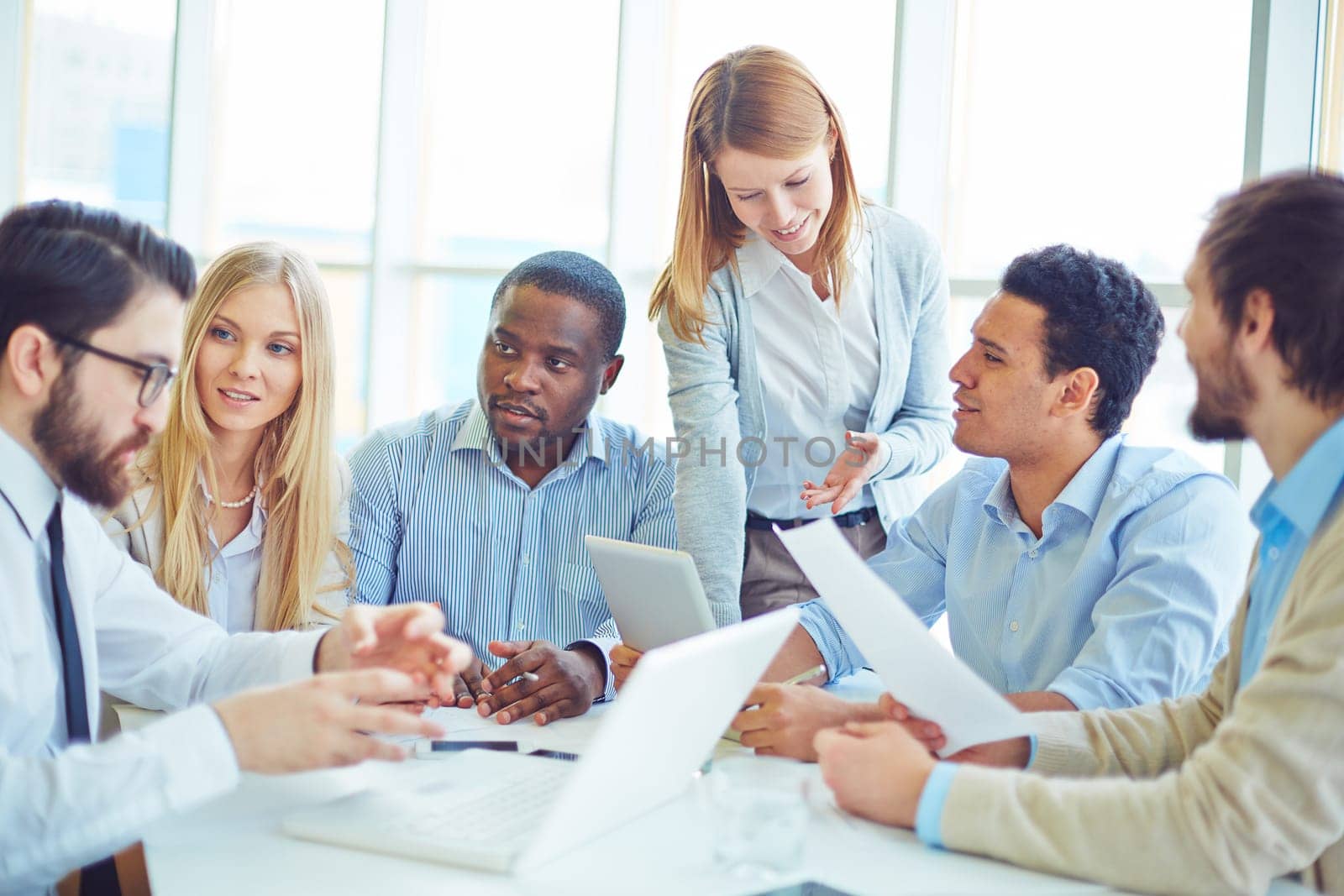 Group of successful professionals communicating in office