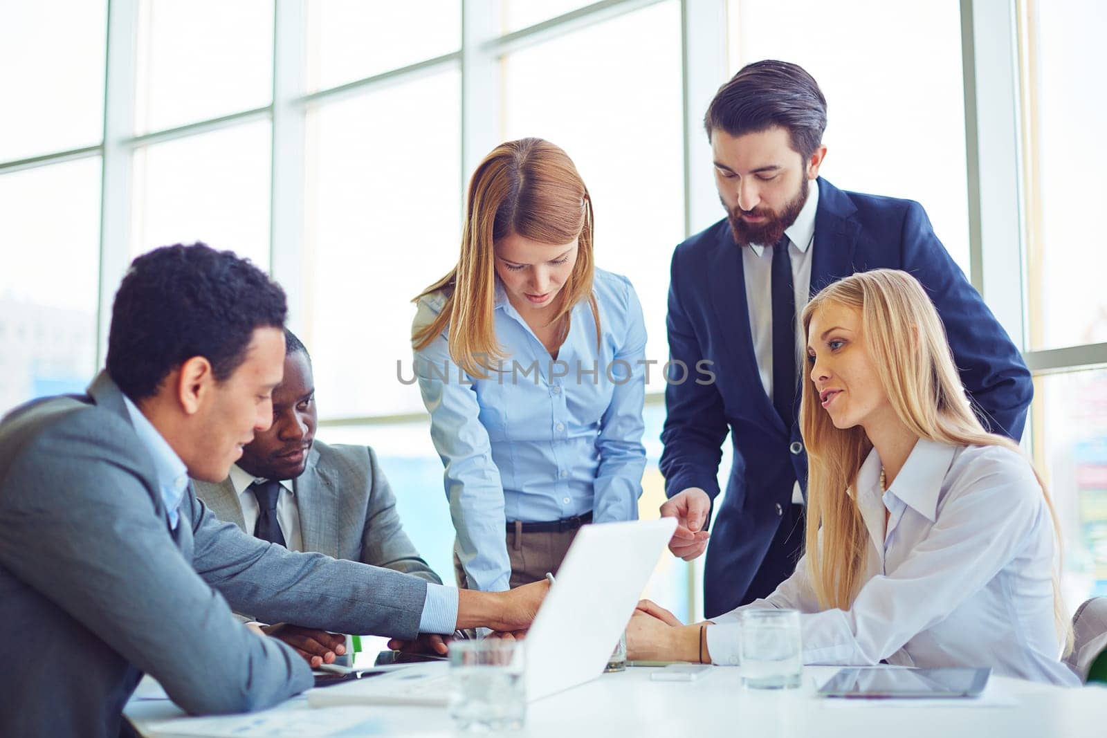 Group of employees discussing ideas and planning work in office