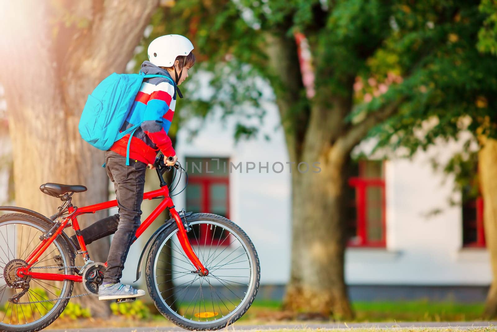 Teenager in the morning quickly riding on bicycle to the lesson. Concept of the back to school.