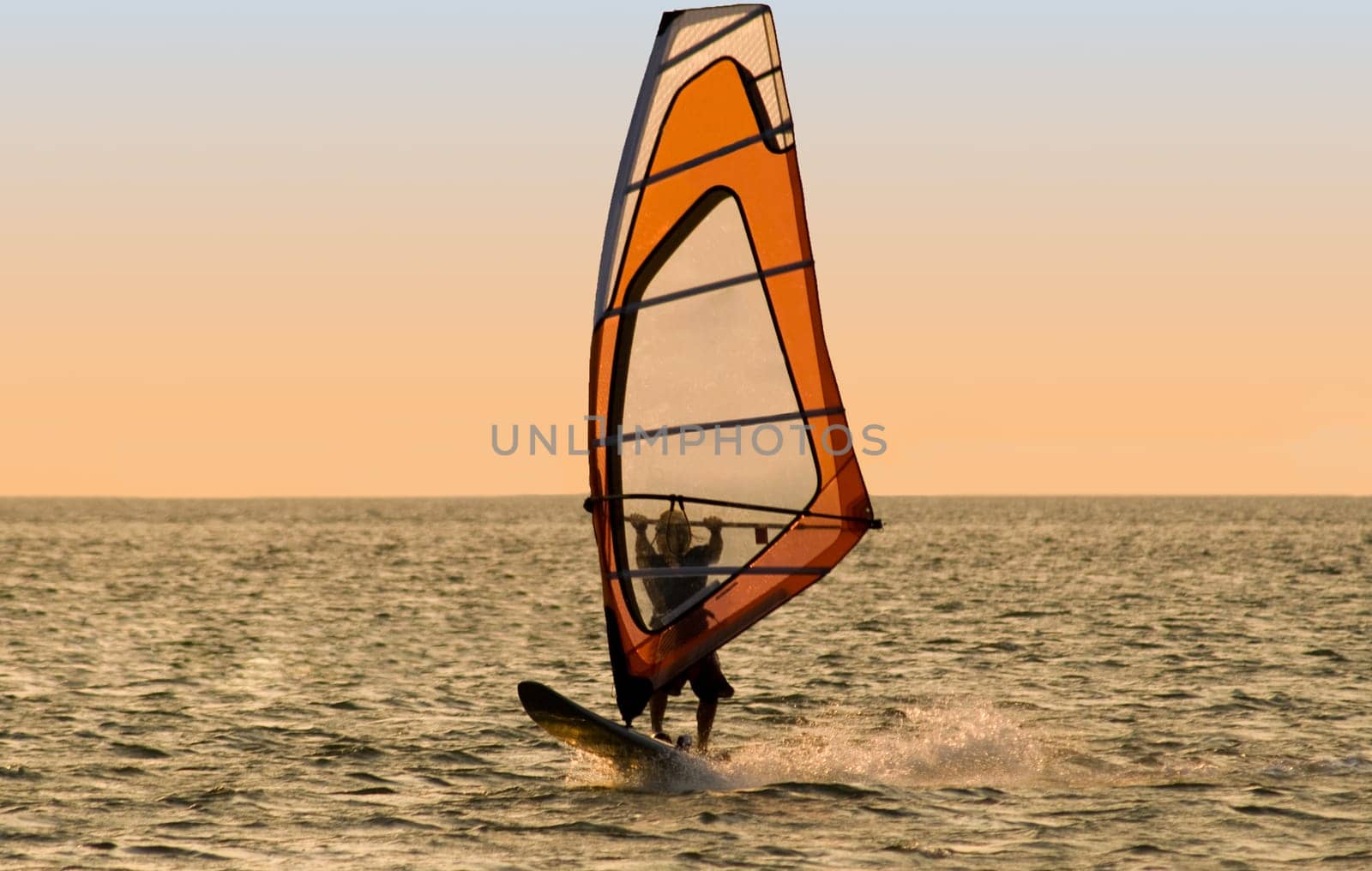 Silhouette of a windsurfer on the sea