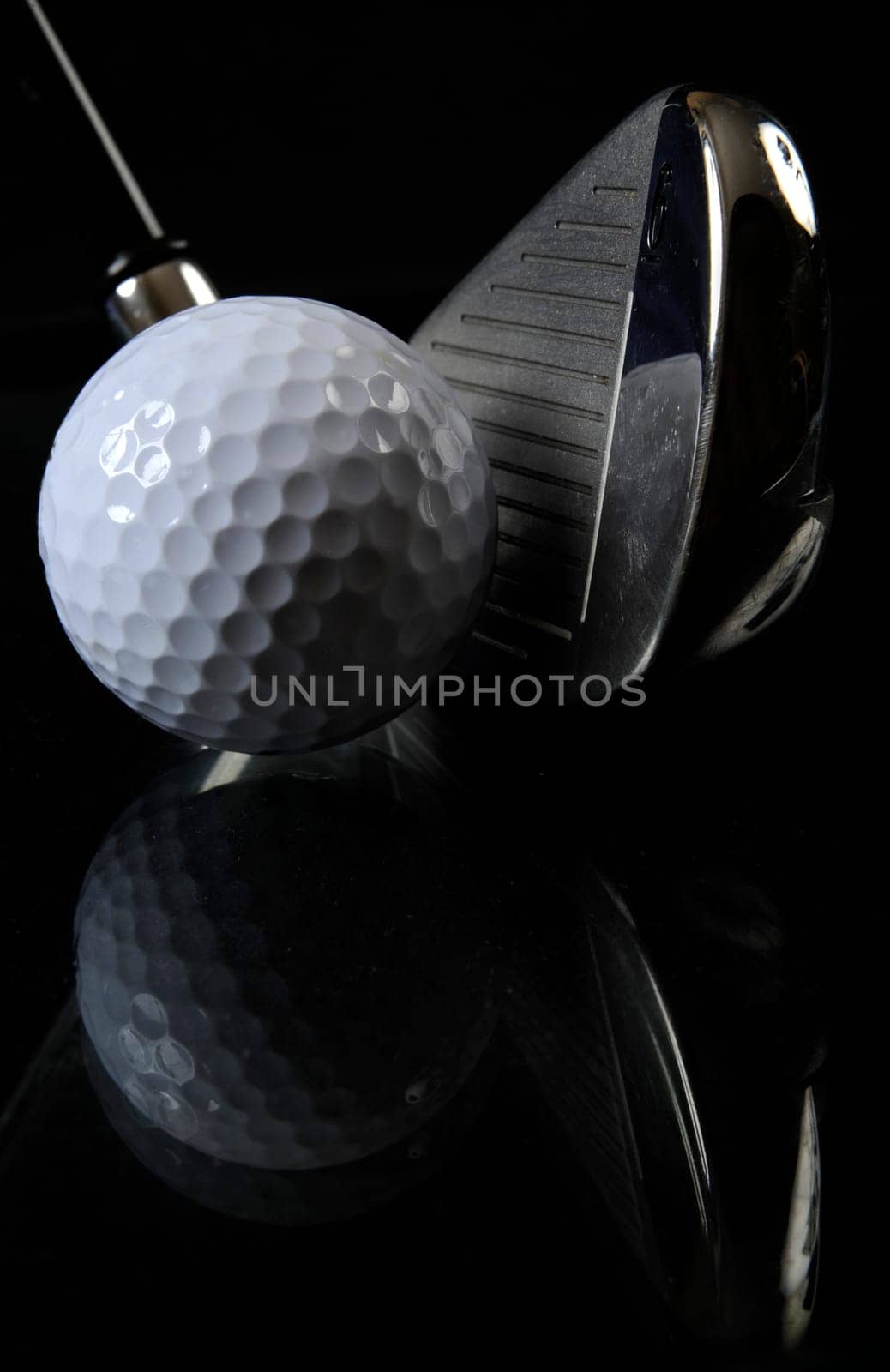 Golf club with ball in the black background
