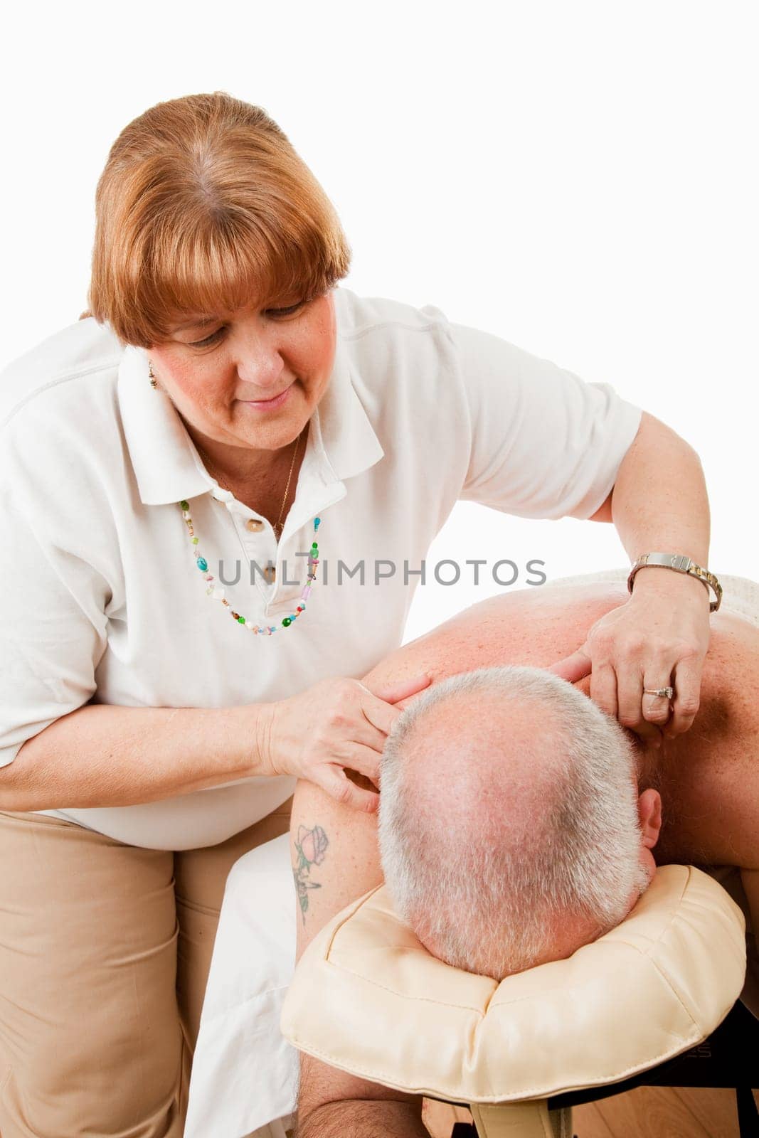 Massage therapist works on relieving tension in her client's shoulders.