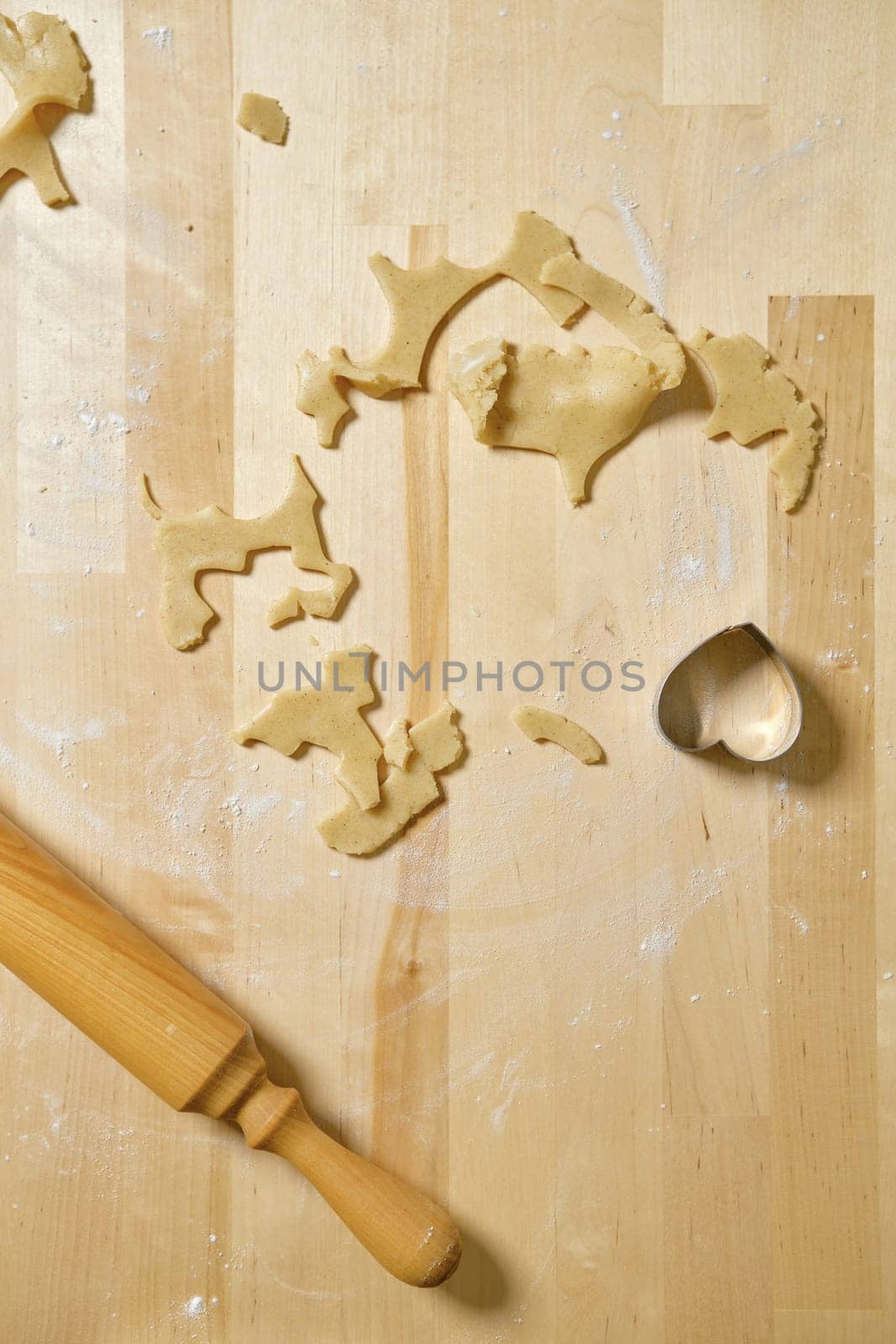 Top view of kitchen table with rests and cuts of cookie dough