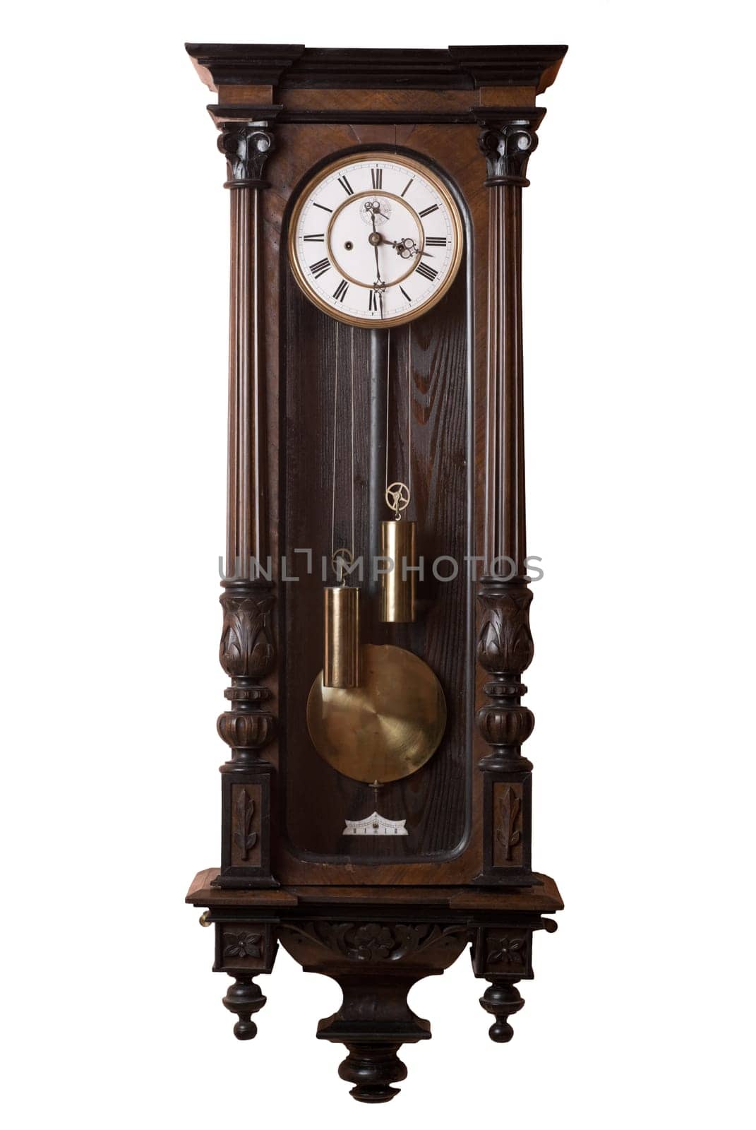 Old pendulum wall clock isolated on white.