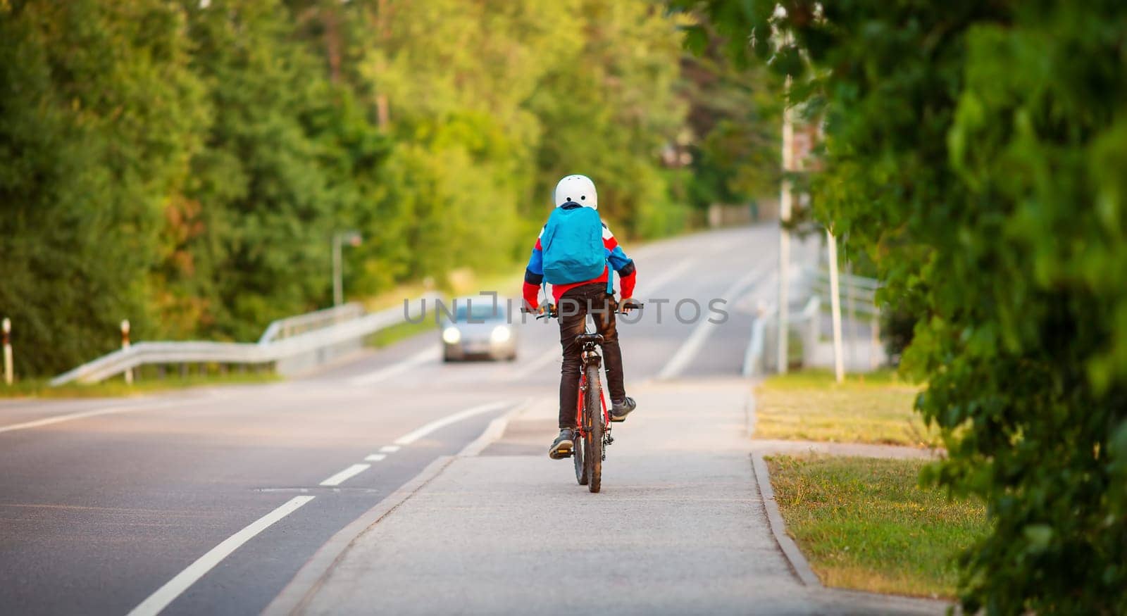 Teenager in the morning hurrying on bicycle to the lesson. Concept of the back to school.