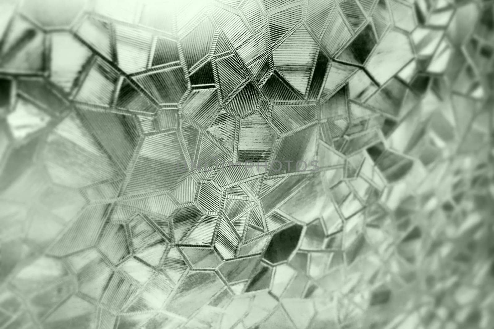 Corrugated glass green background. Abstract pattern on the surface of a window. Protective opaque film