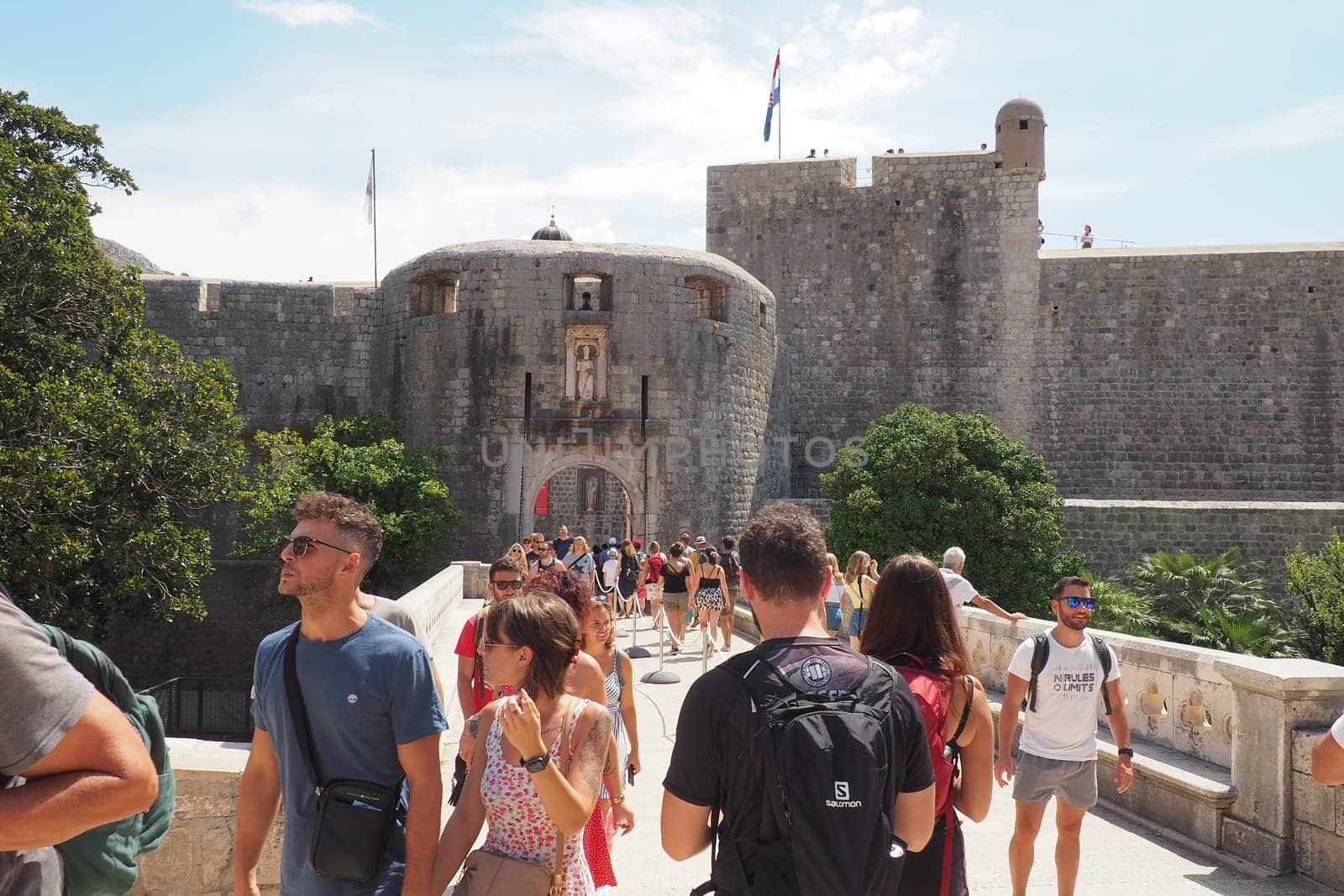 Pile Gate Dubrovnik Croatia August 14 2022 People men and women walk along the stone bridge to the gate of the Old City. Crowd of tourists. Busy entrance. The main entrance to Old Town, busy Pile Gate
