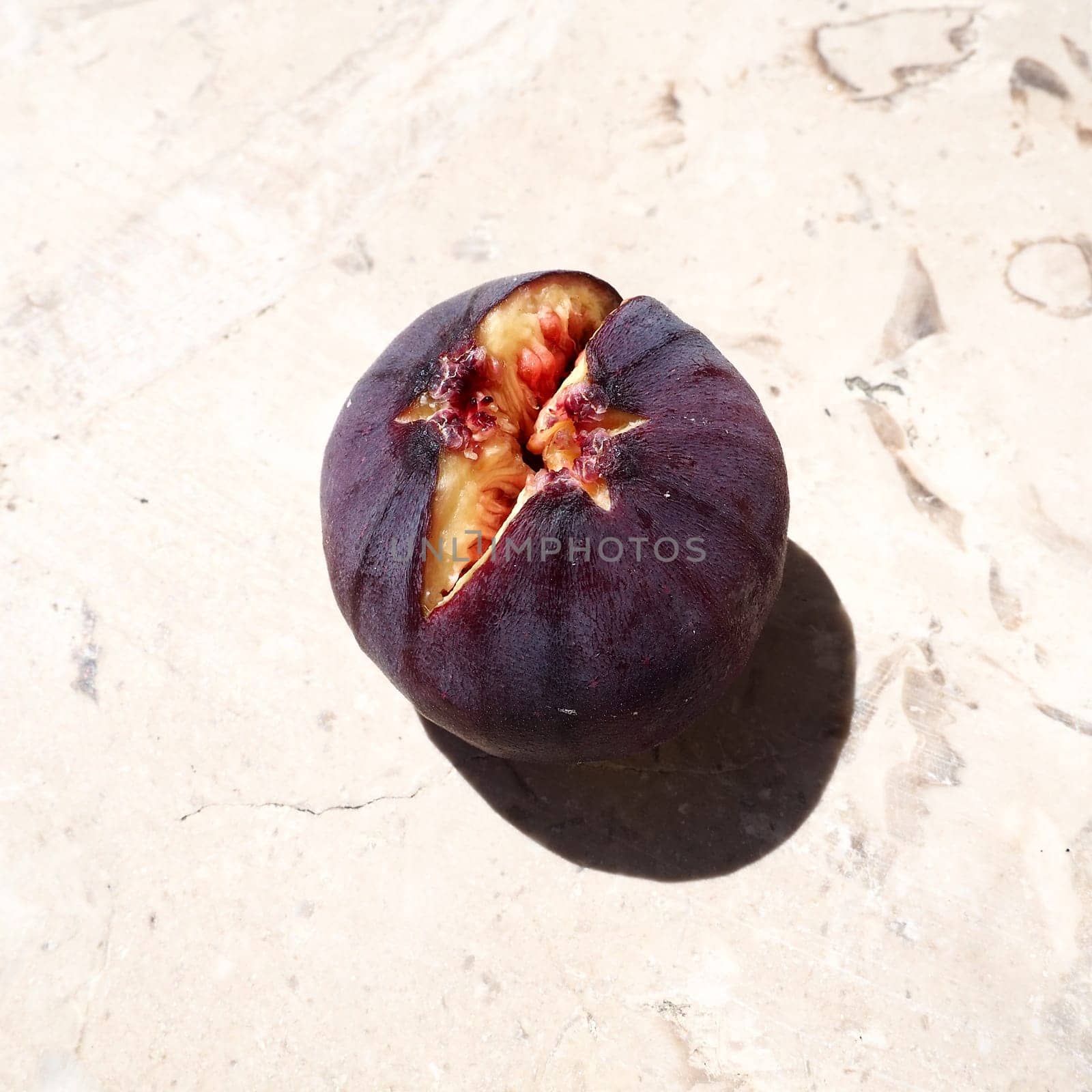 Fig or fig tree, or common fig tree, or Ficus carica is a subtropical deciduous plant of the genus Ficus of the Mulberry family. Ripe purple fig fruits on a light background. Healthy food.