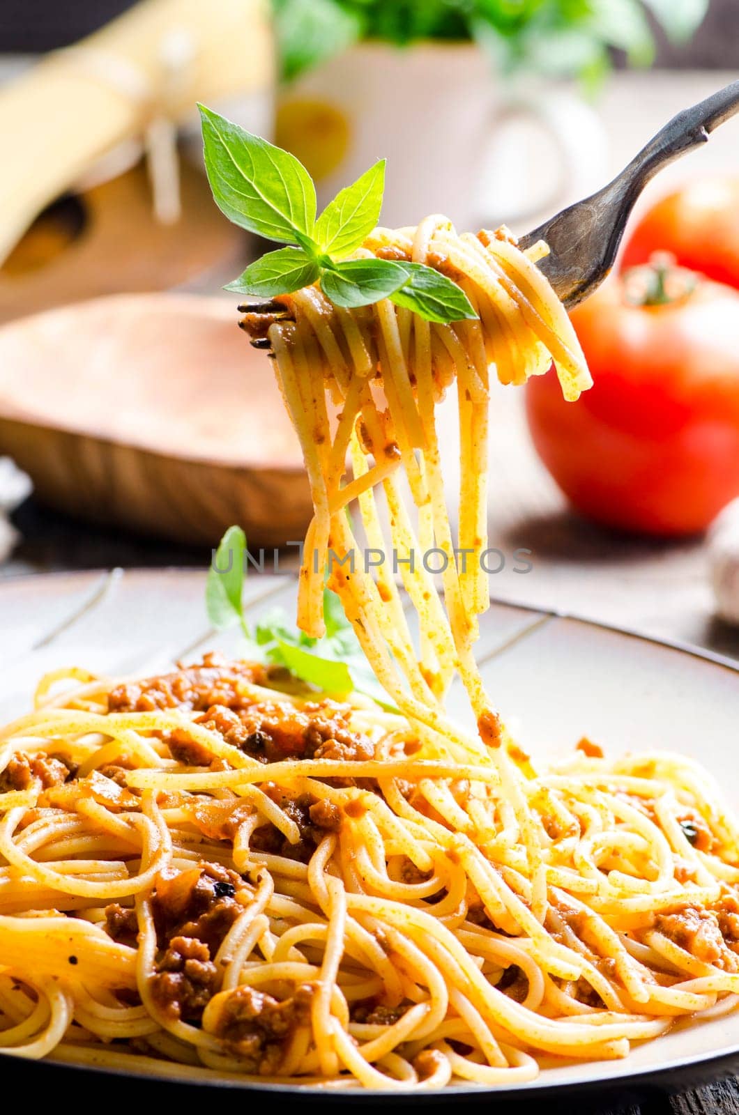 Closeup of italian spaghetti bolognese with basil serve on plate. Traditional homemade italian food recipe. Cooking and gastronomy concept.