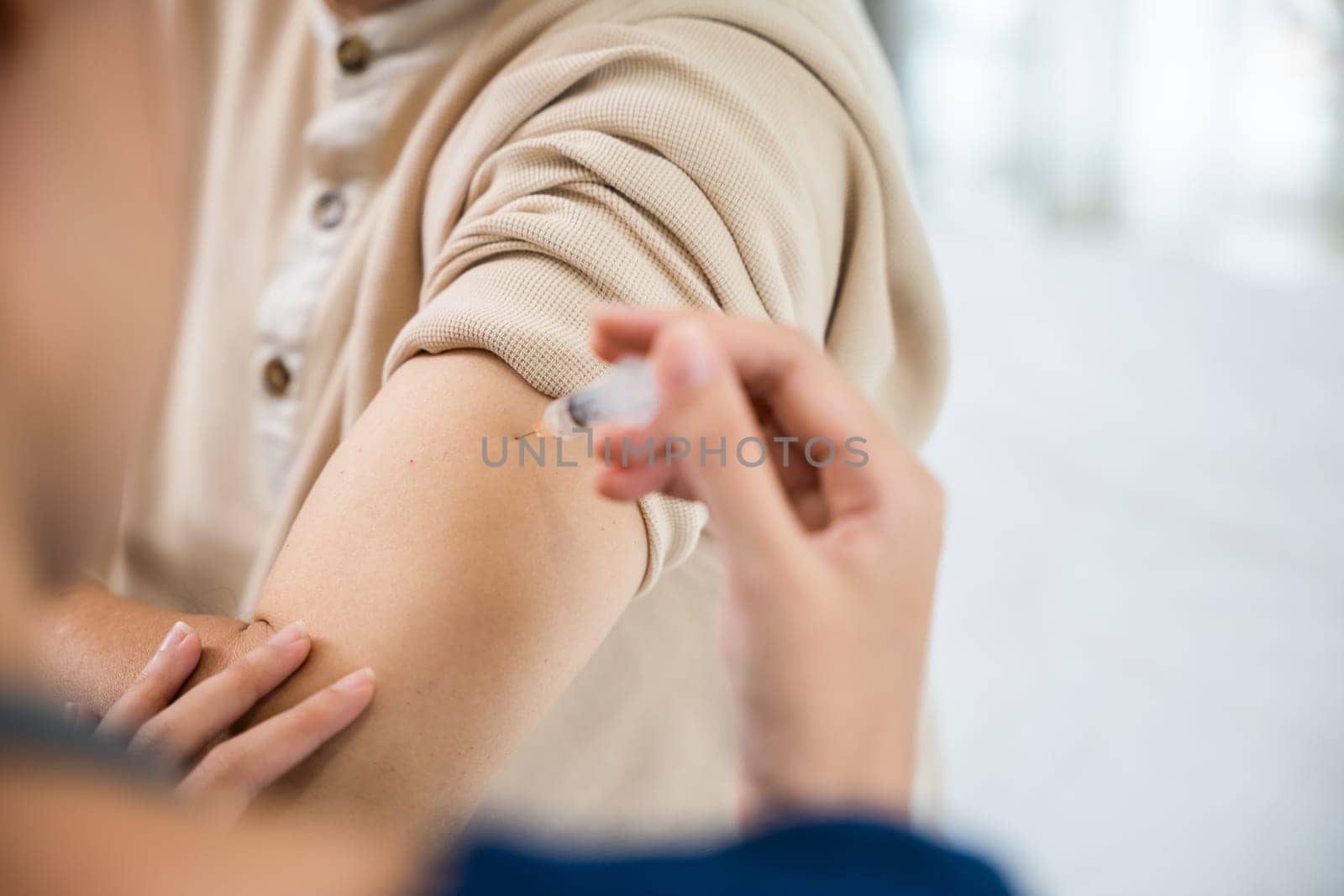Asian elderly old man getting coronavirus vaccine with nurse, Doctor giving injection with syringe to senior man at clinic or hospital, medical and healthcare