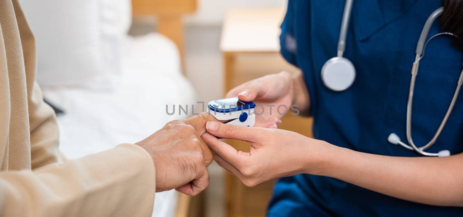 Young woman putting digital oximeter of finger middle aged adult patient man, Asian nurse checking with fingertip pulse oximeter oxygen saturation meter blood monitor finger senior old man at hospital