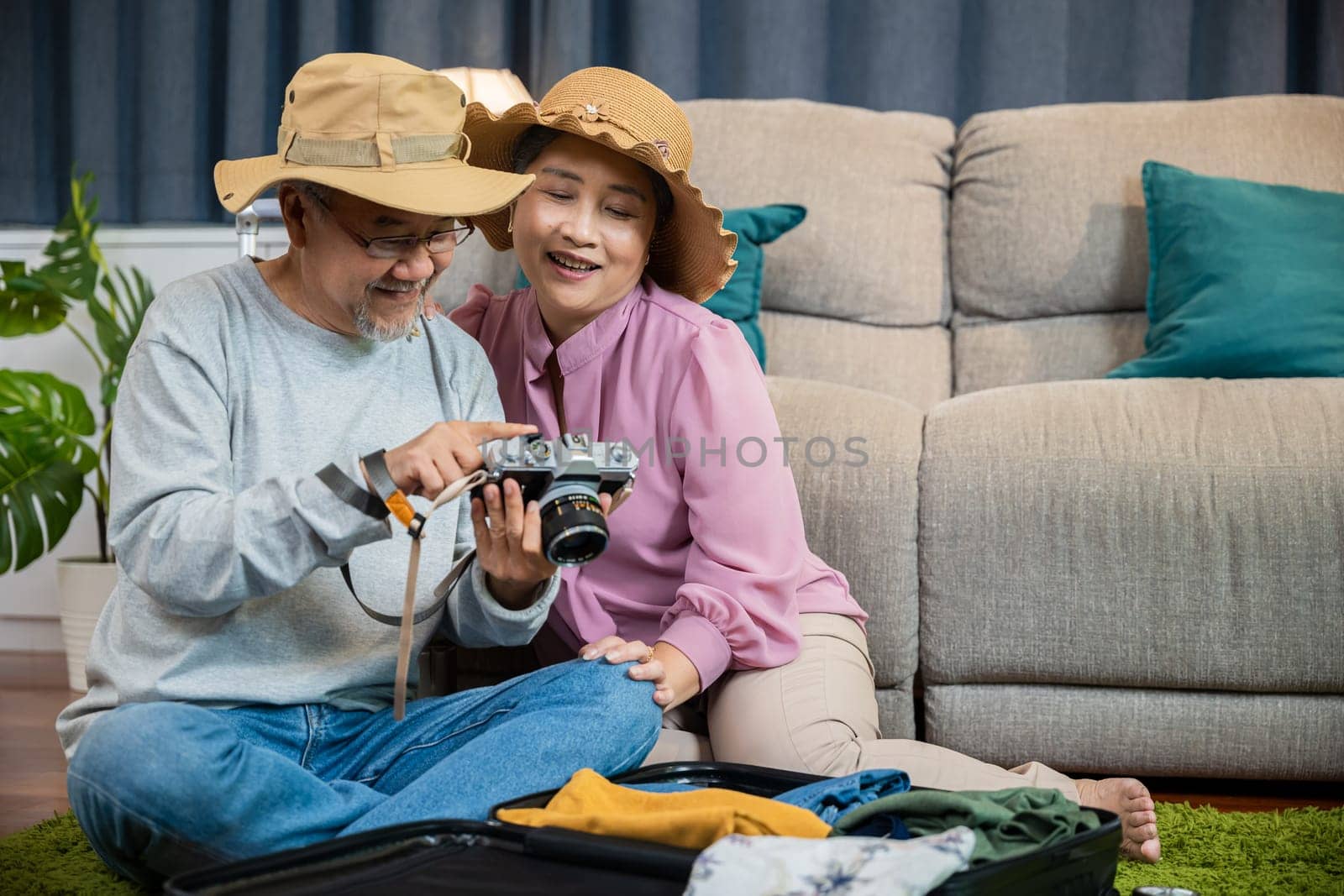 Travel and tourism. Happy mature retired couple photography weekend holiday, Asian couple old senior marry retired couple smiling taking photo by camera during luggage suitcase arranging for travel