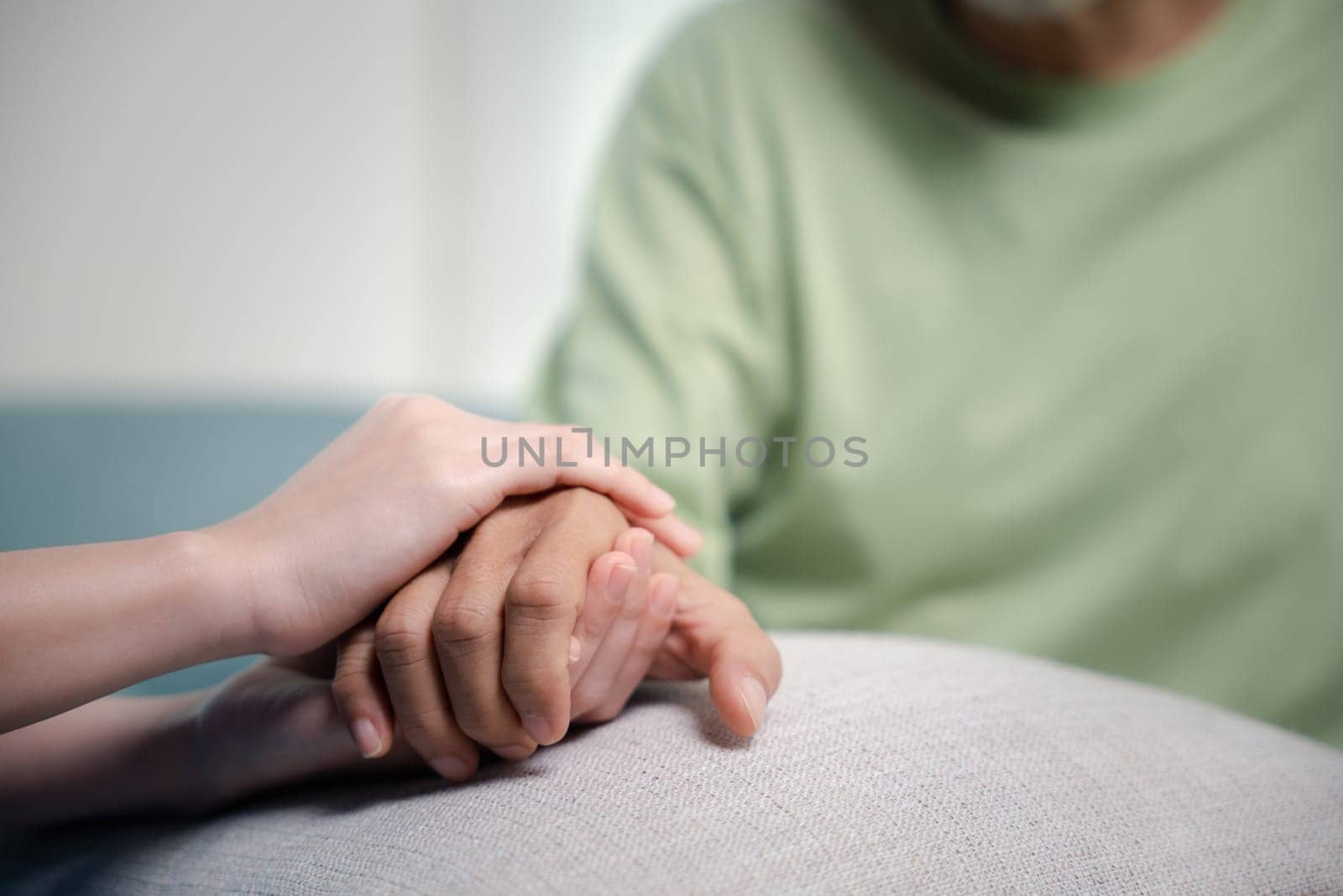 International Day for the Elderly. Caring nurse helping elderly old man care facility gets help from hospital, young woman helping hands offering her senior man at home, old aged