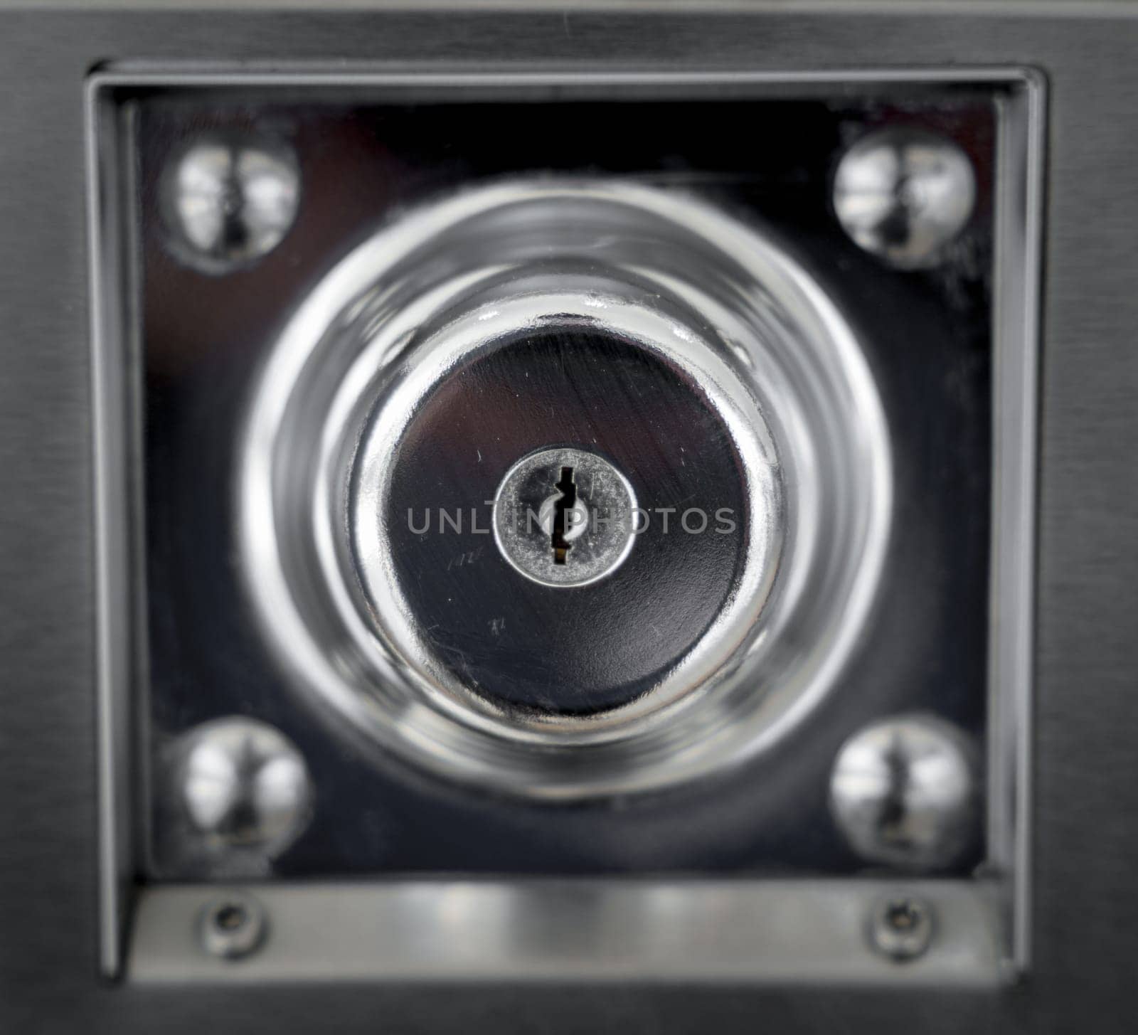 Keyholes. close up detail modern round metal key hole steel door, security safety protect