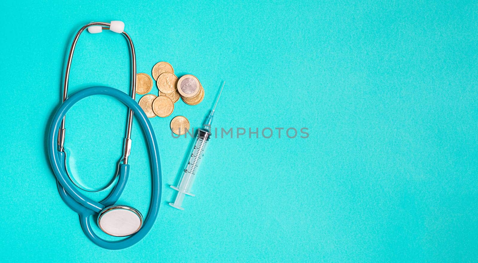 Concept of scientific research in medicine. Biotechnology banner with medical syringe stethoscope and money. Copyspace for text. flatlay.
