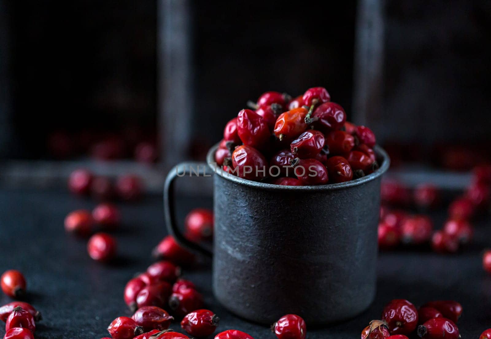 Rosehip in the cup. Benefits and used as a natural remedy. Natural therapy. dark mode style.