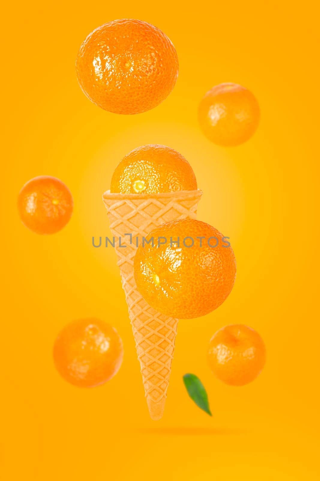 Falling ice cream cone with mandarin fruits. Seven flying whole tangerines on colored table with clipping path as package design element and advertising. Selective focus.