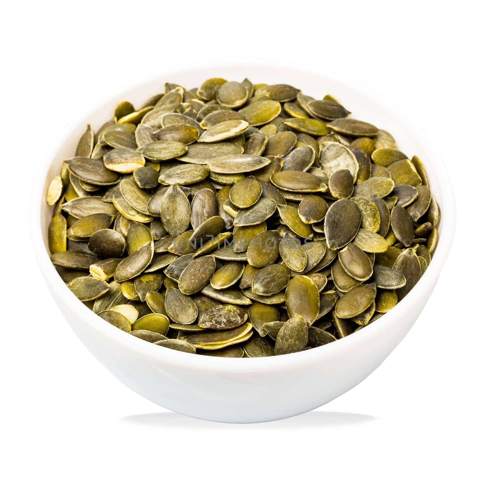 Bowl of pumpkin seeds isolated on white. Top view. Organic food