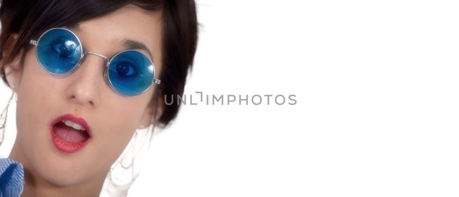 a beautiful young brunette woman with blue glasses on white
