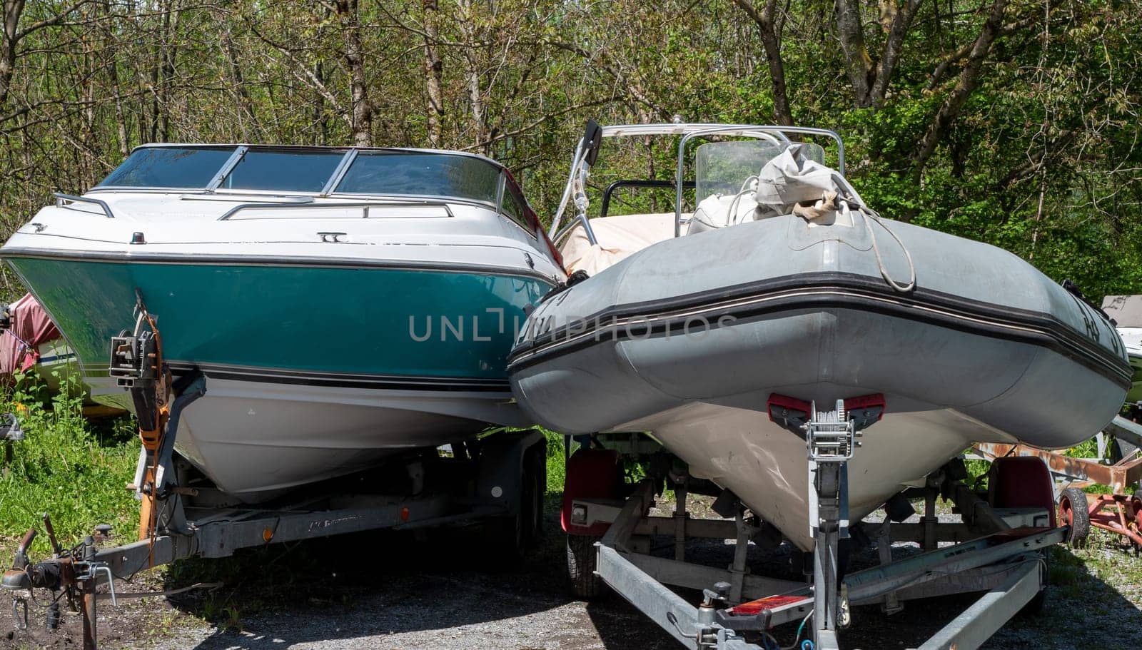 Two motor boats on the trailers at parking