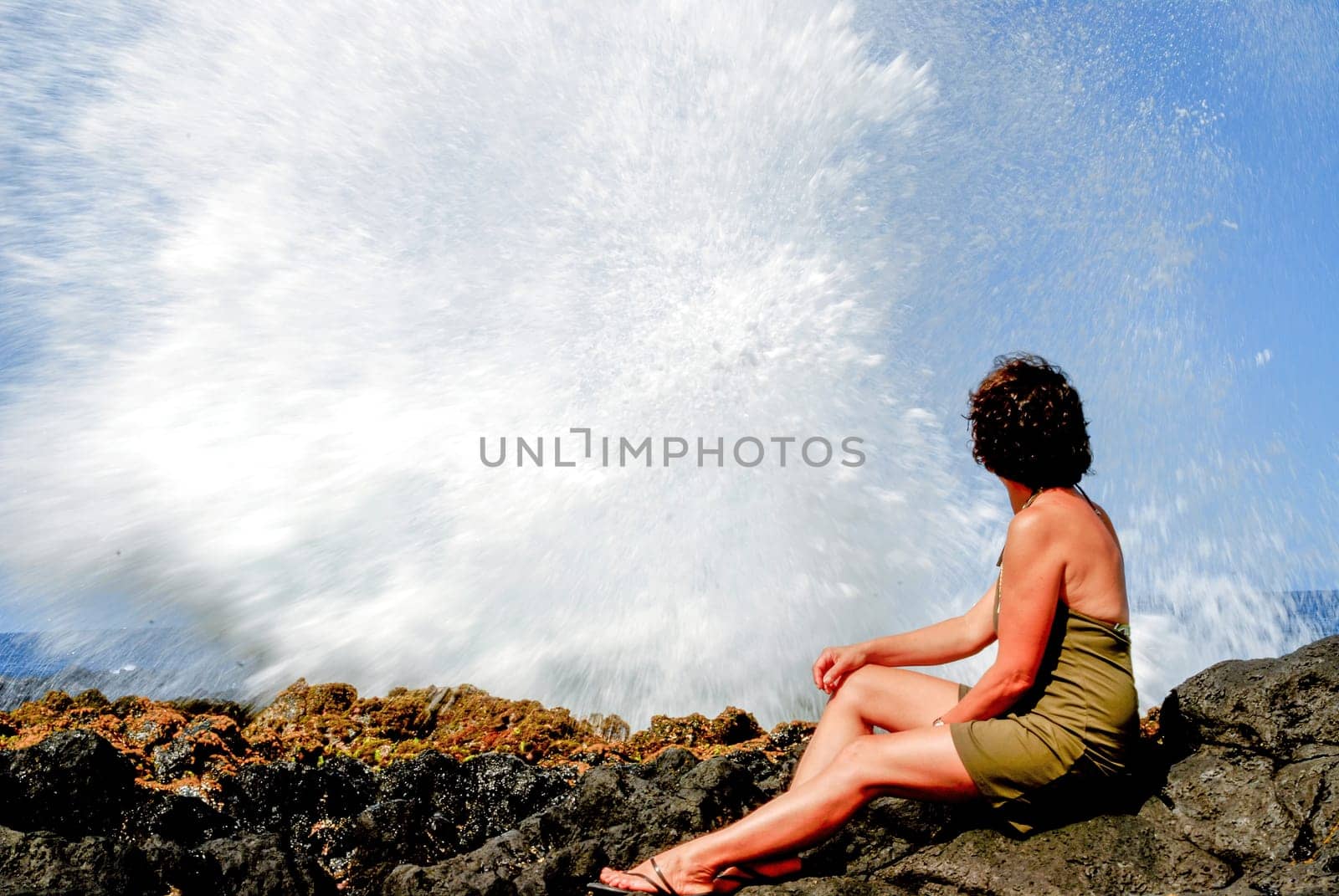 a woman near Le Souffleur geyser at Reunion Island close to Saint Leu city