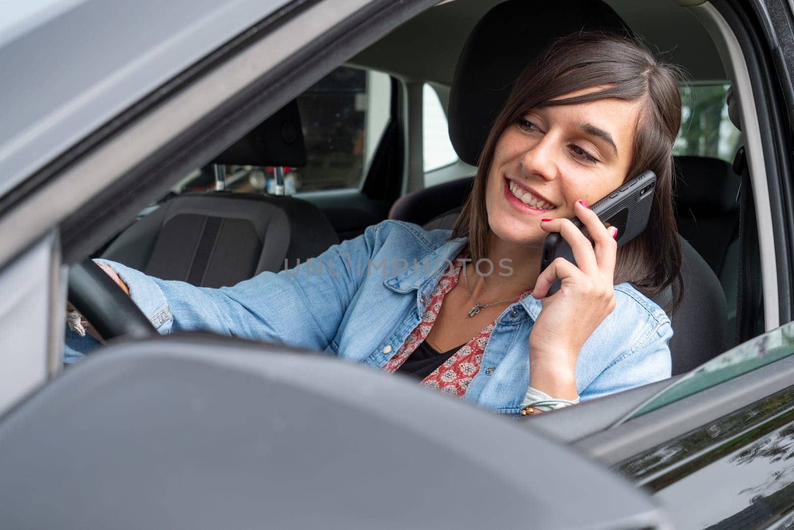 Woman use mobile phone in a car