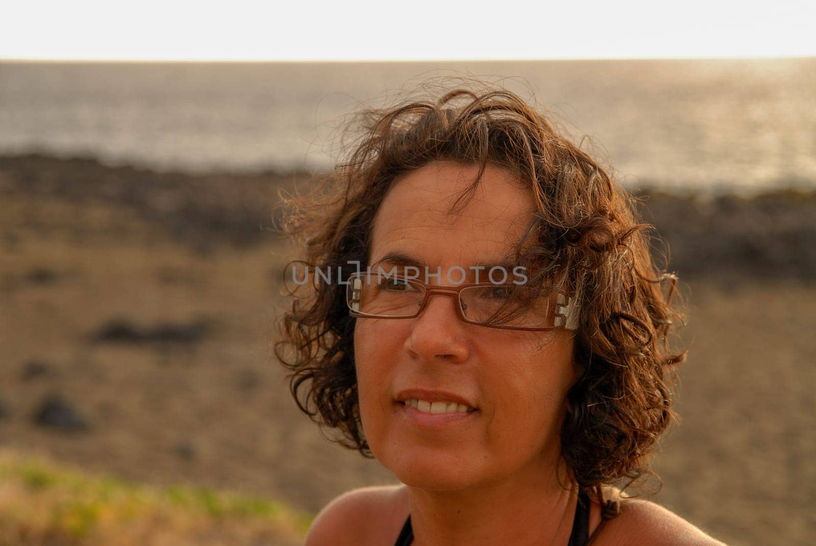 a portrait of beautiful brunette mature woman with eyeglasses