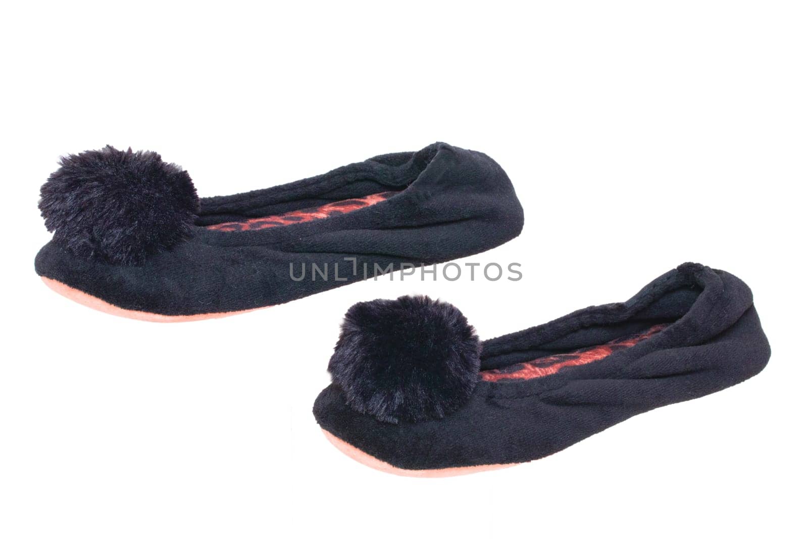 Slippers isolated. Close-up of a pair of black female house slippers isolated on a white background. Woman shoes.