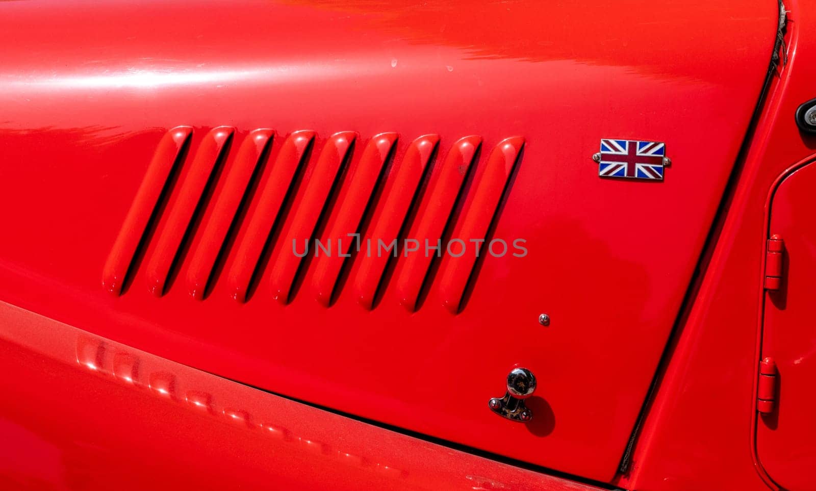 a detail of the bonnet of a red car